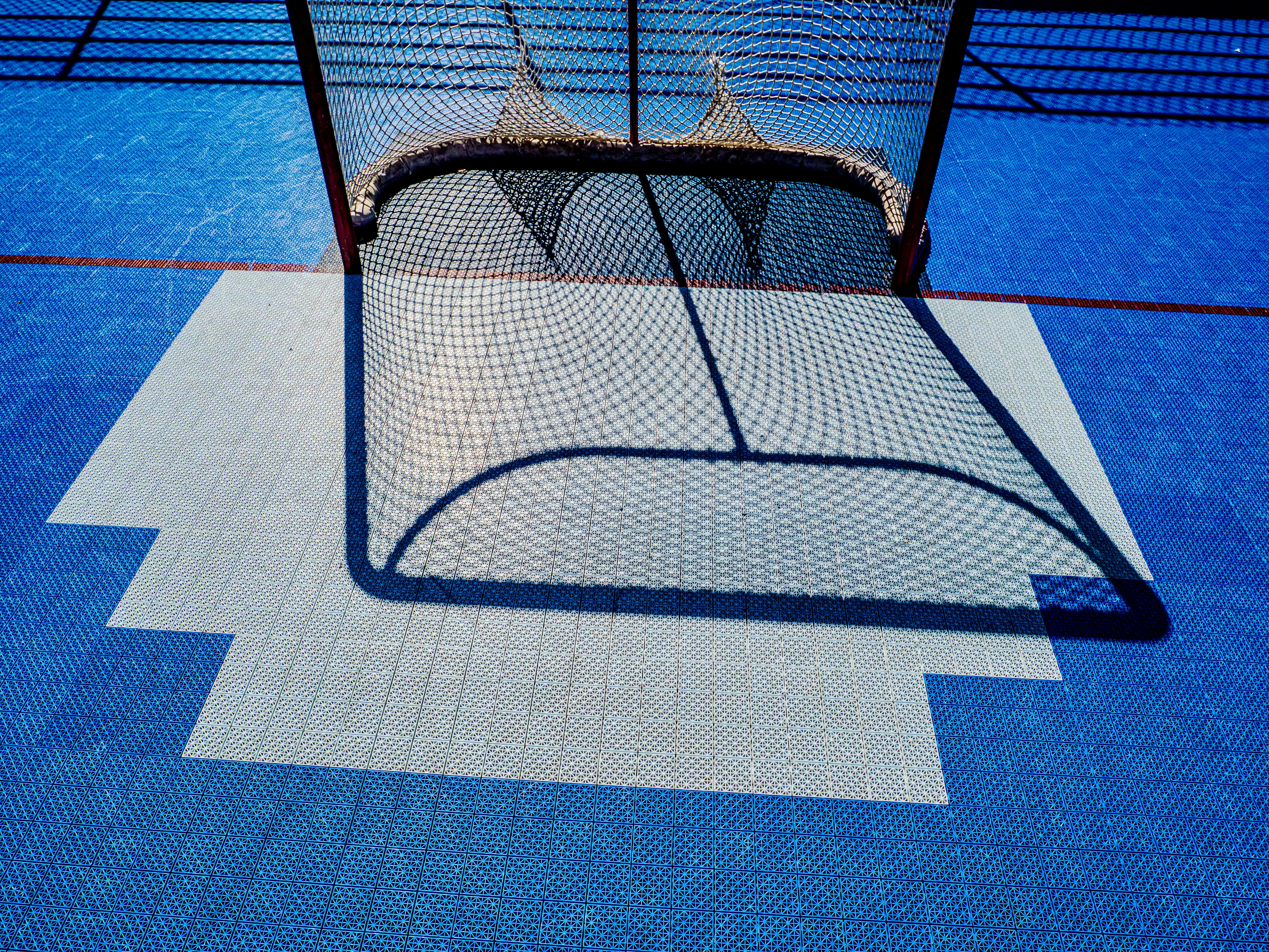 Hockey net on a blue rink with white markings