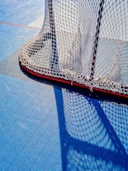 Hockey goal net on blue ice surface
