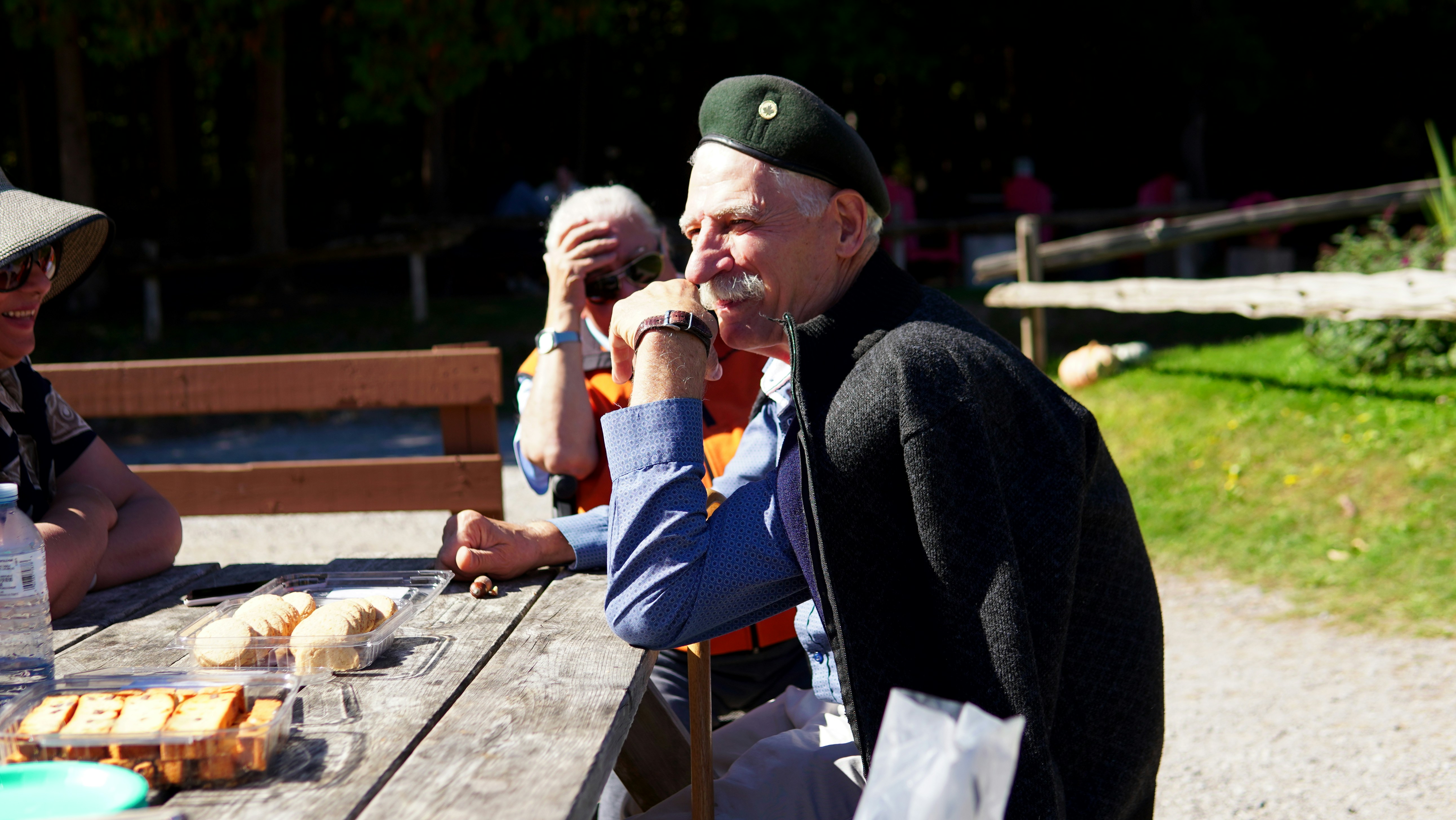 A group of seniors enjoying a social activity together, like playing cards or talking in a cafe.