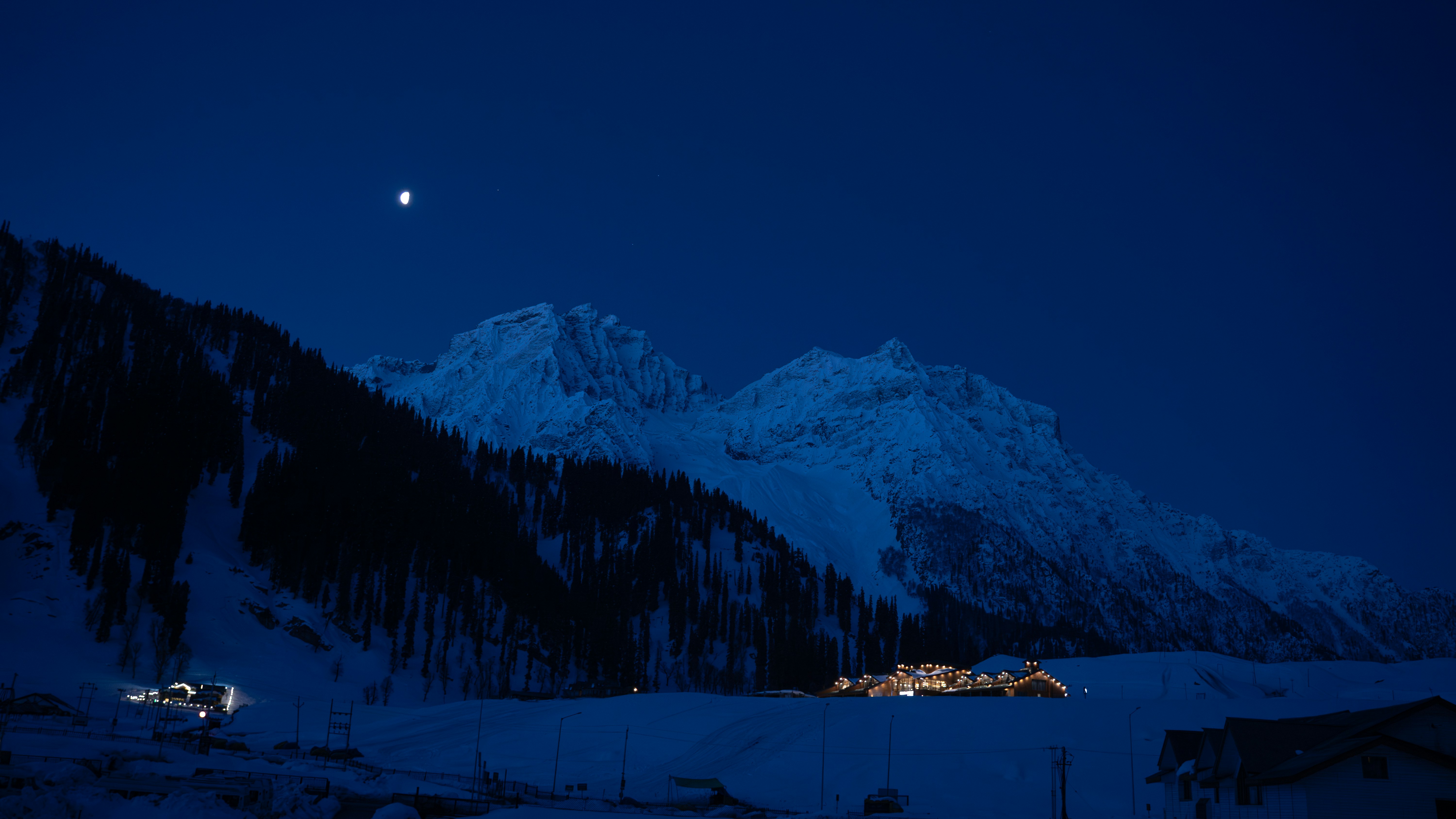 Snowy mountains under a clear night sky.