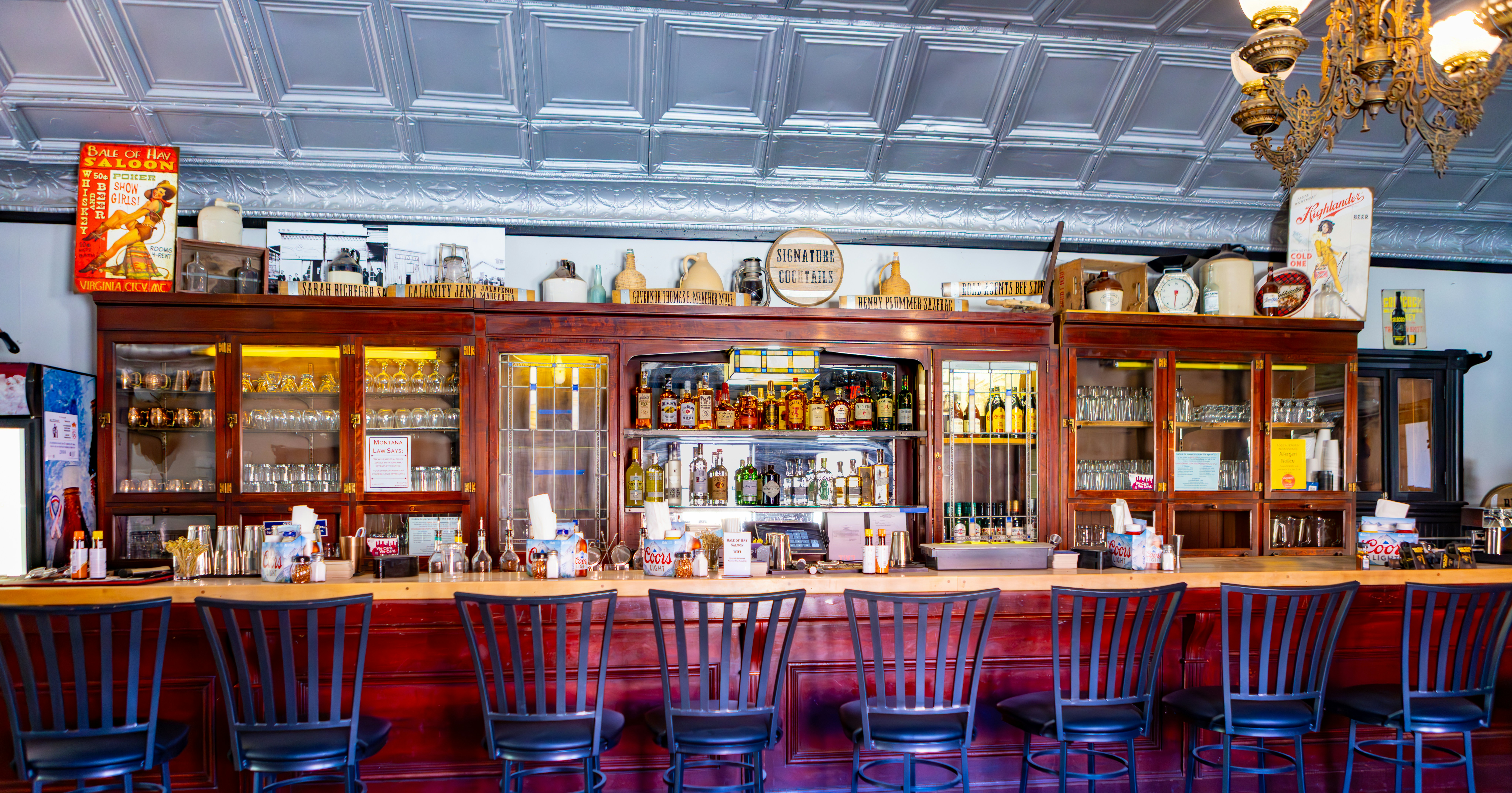 Antique bar with wooden counter and stools