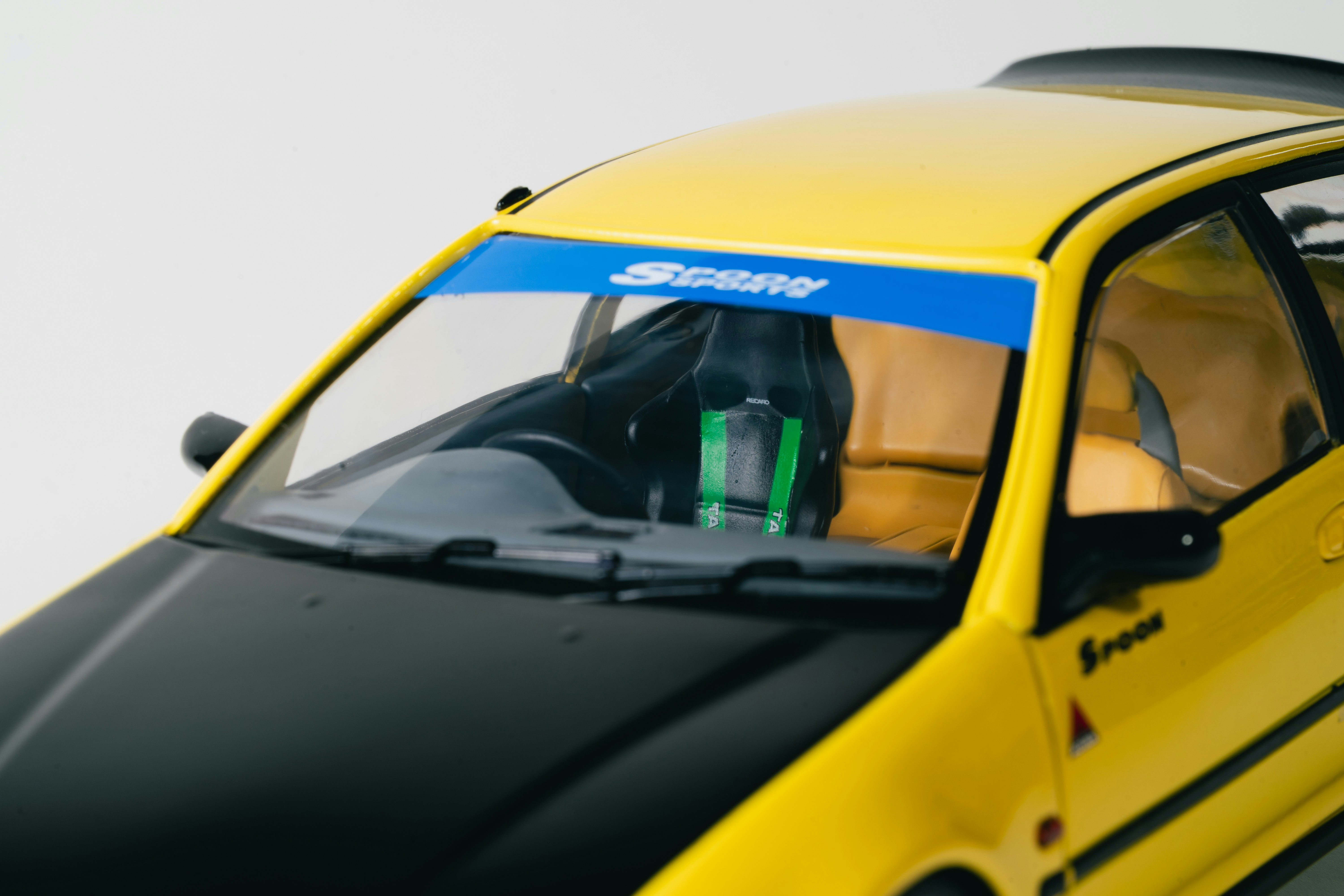 Yellow car with racing seat and blue banner