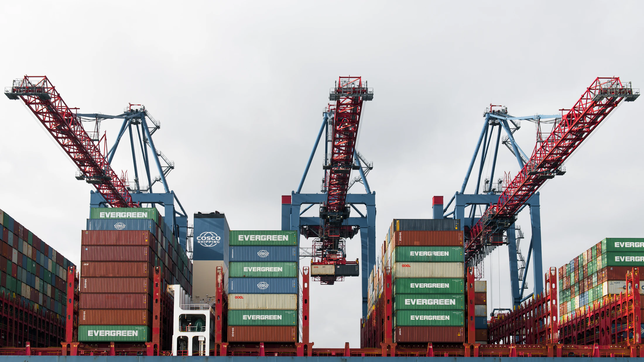 Cargo cranes loading a container vessel at port