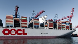 Large cargo ship loaded with containers at port.