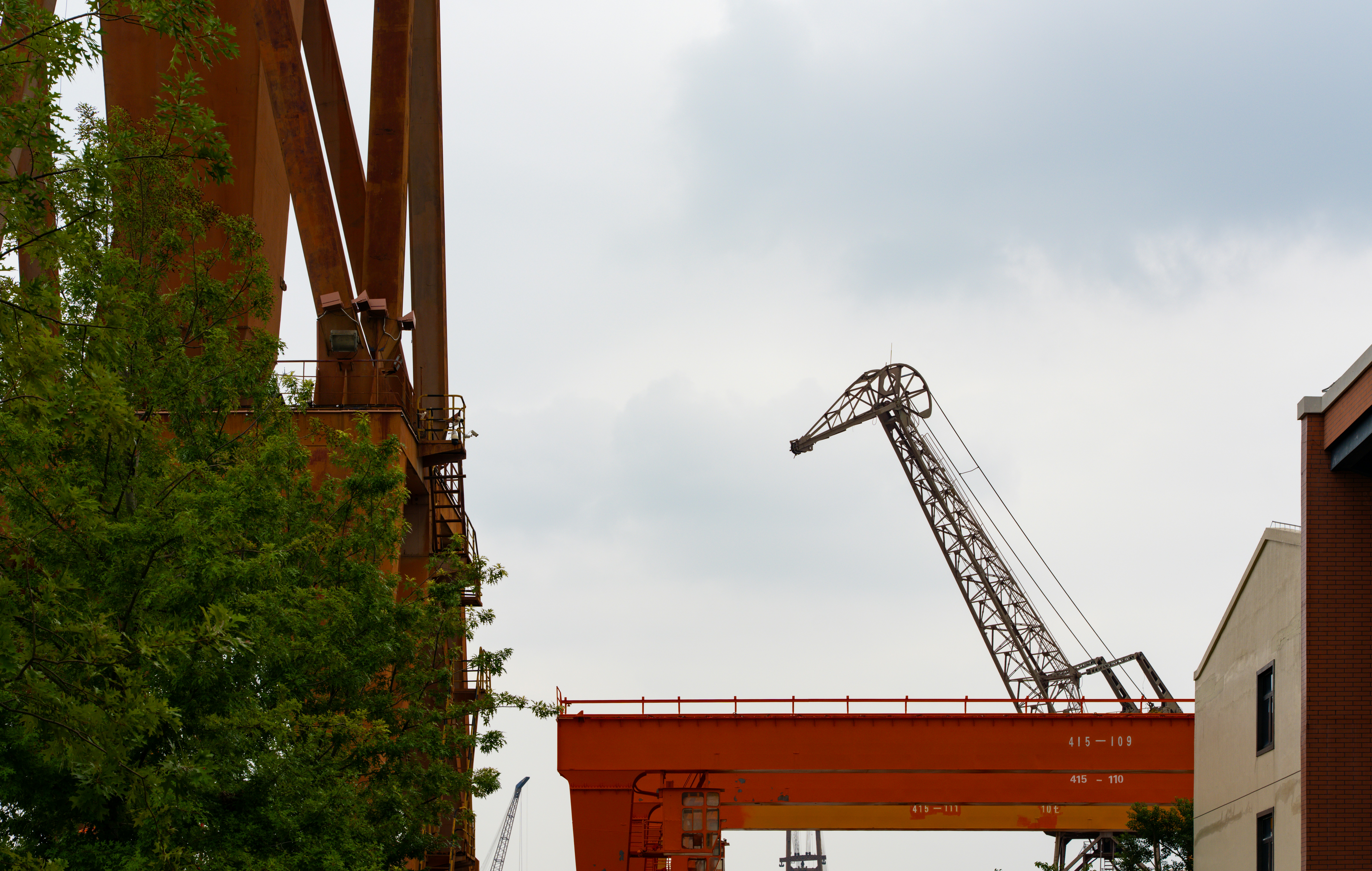 Industrial cranes against a cloudy sky