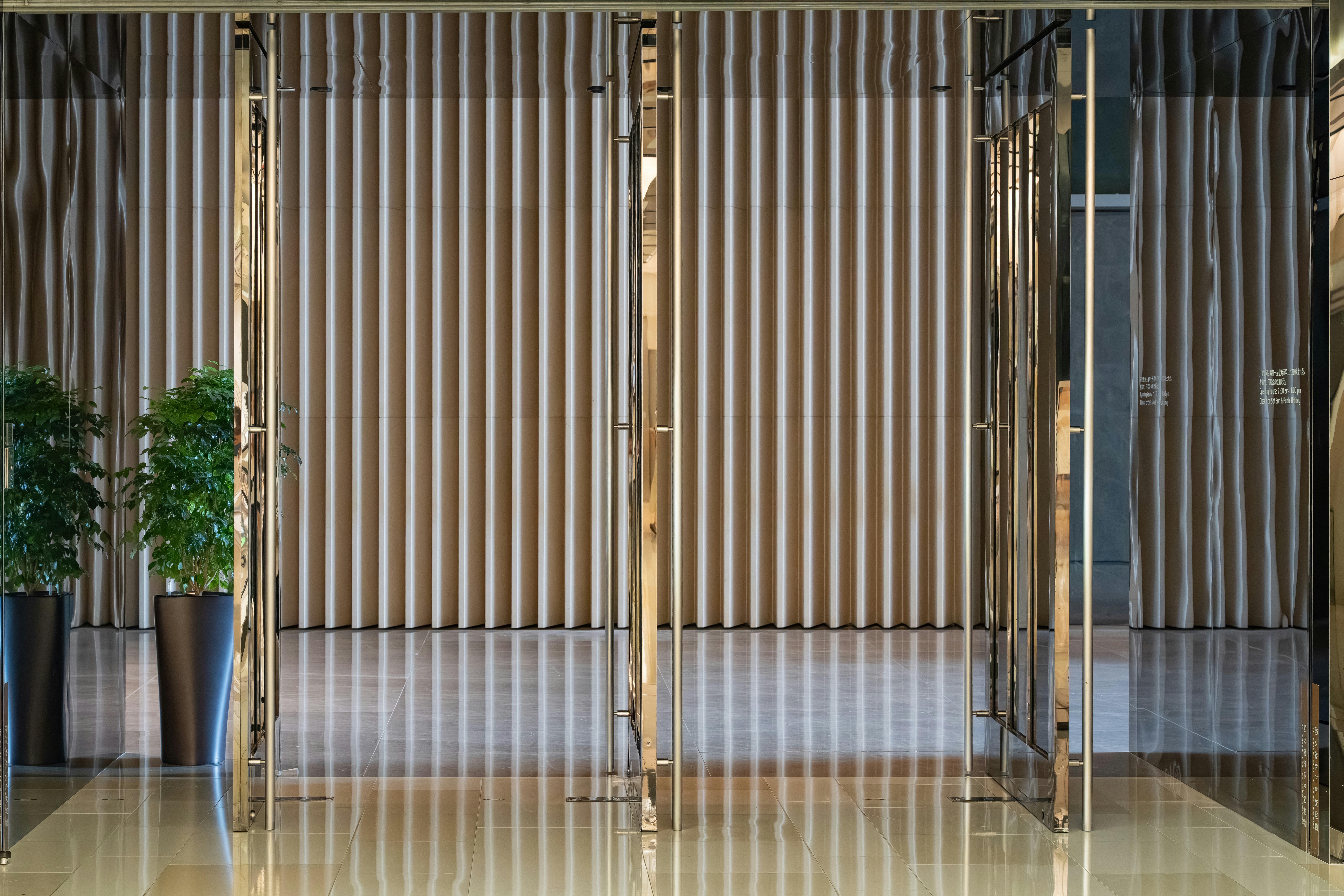 Modern entrance with striped curtains and plants