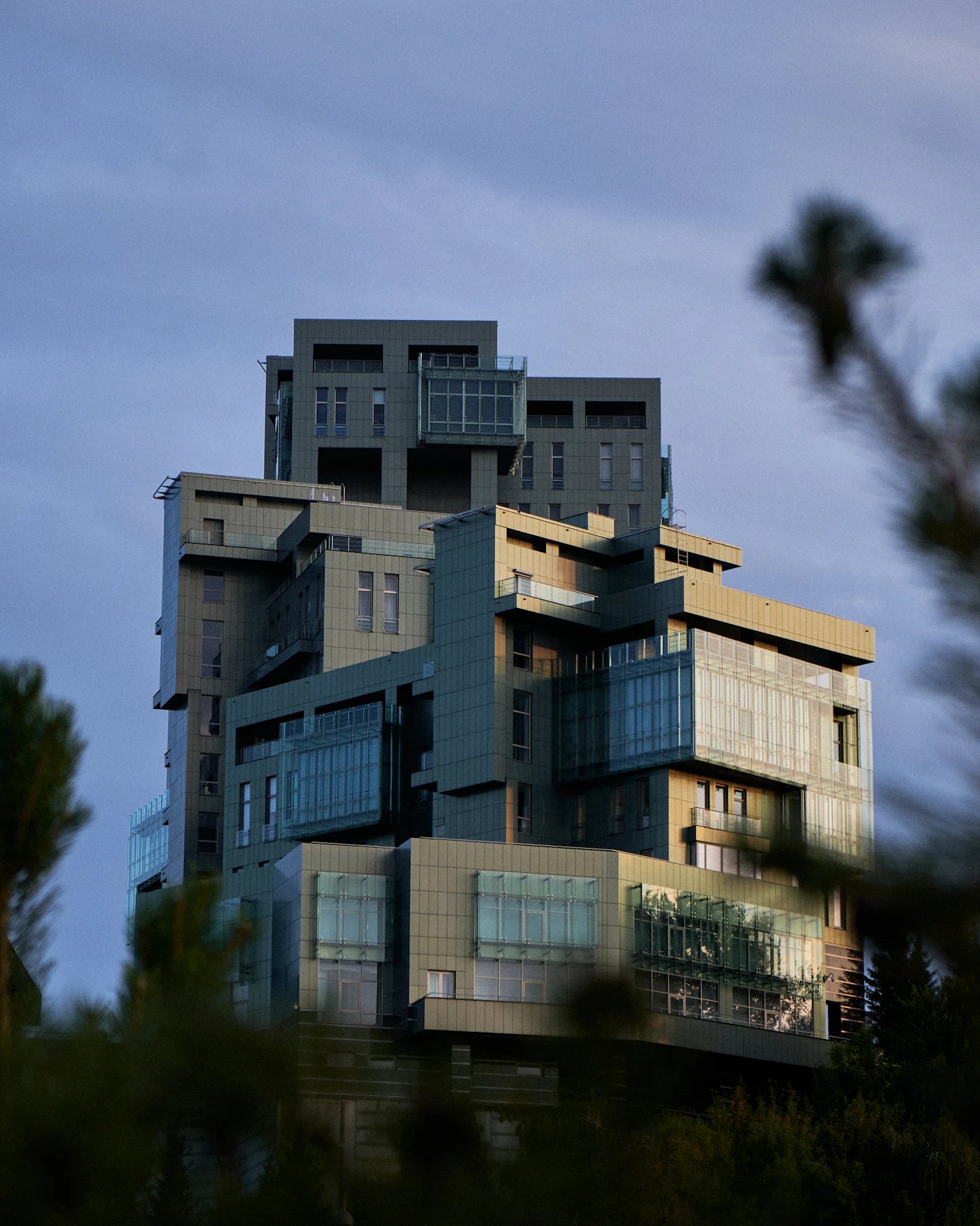 A modern building with an angular facade against the sky.