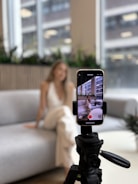 Woman recording herself on a smartphone tripod