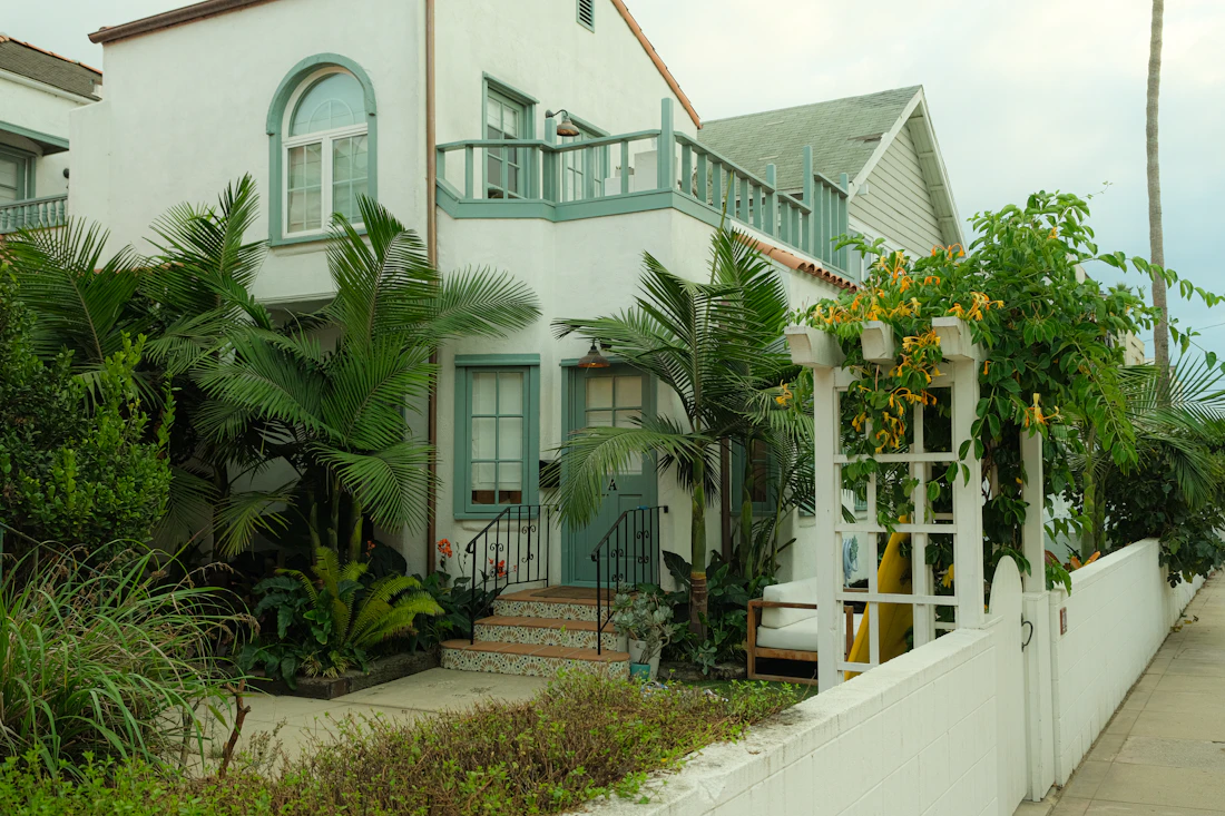White stucco house with green landscaping
