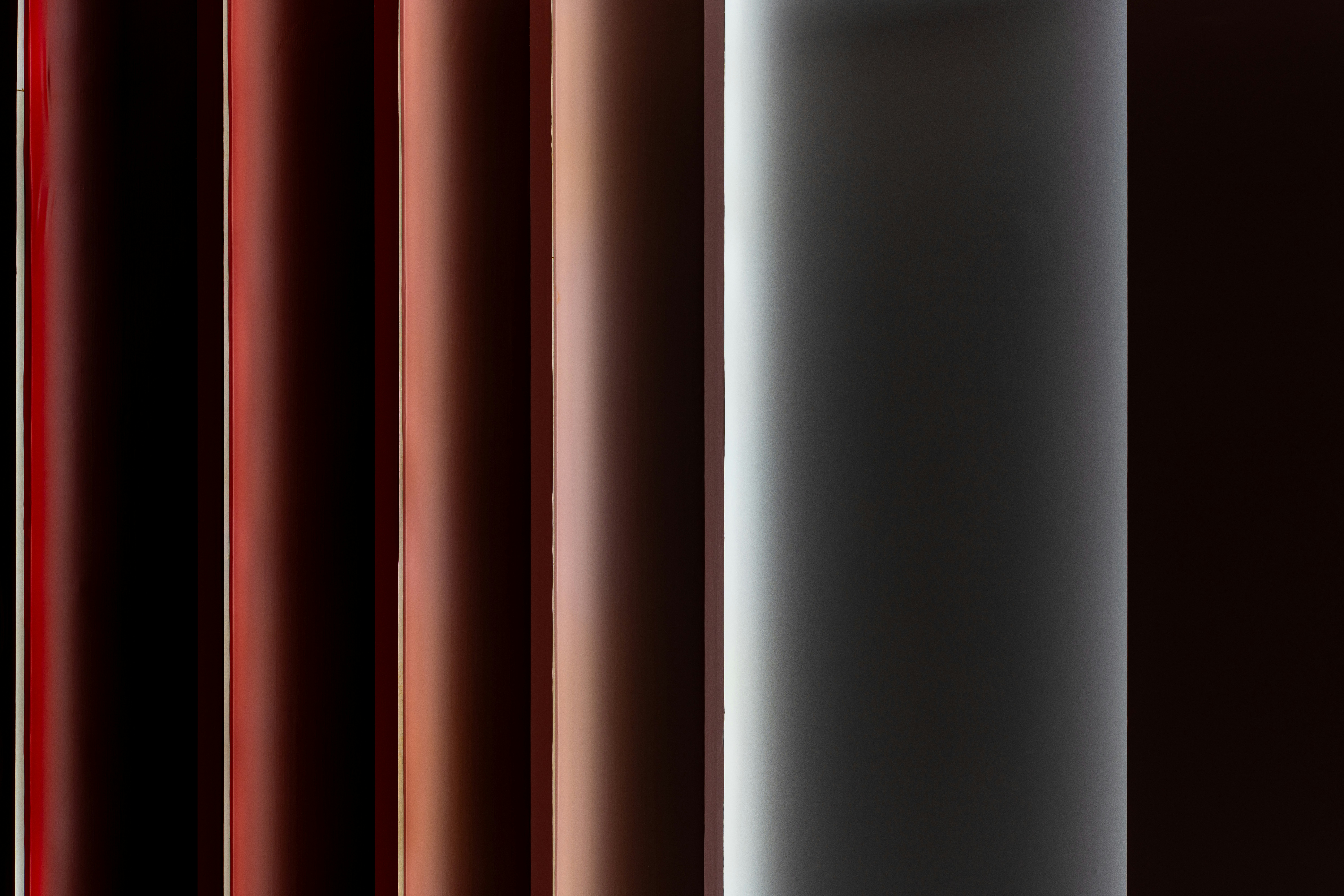 Abstract vertical lines in warm, muted tones.