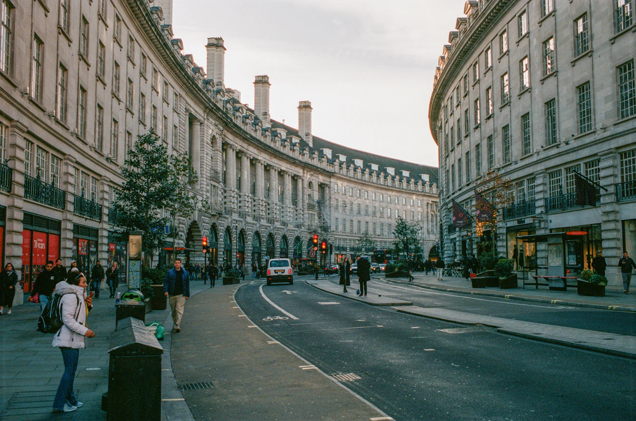 Curved London street lined with classical architecture and shops