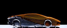 Abstract sculpture of a car with orange and silver details.