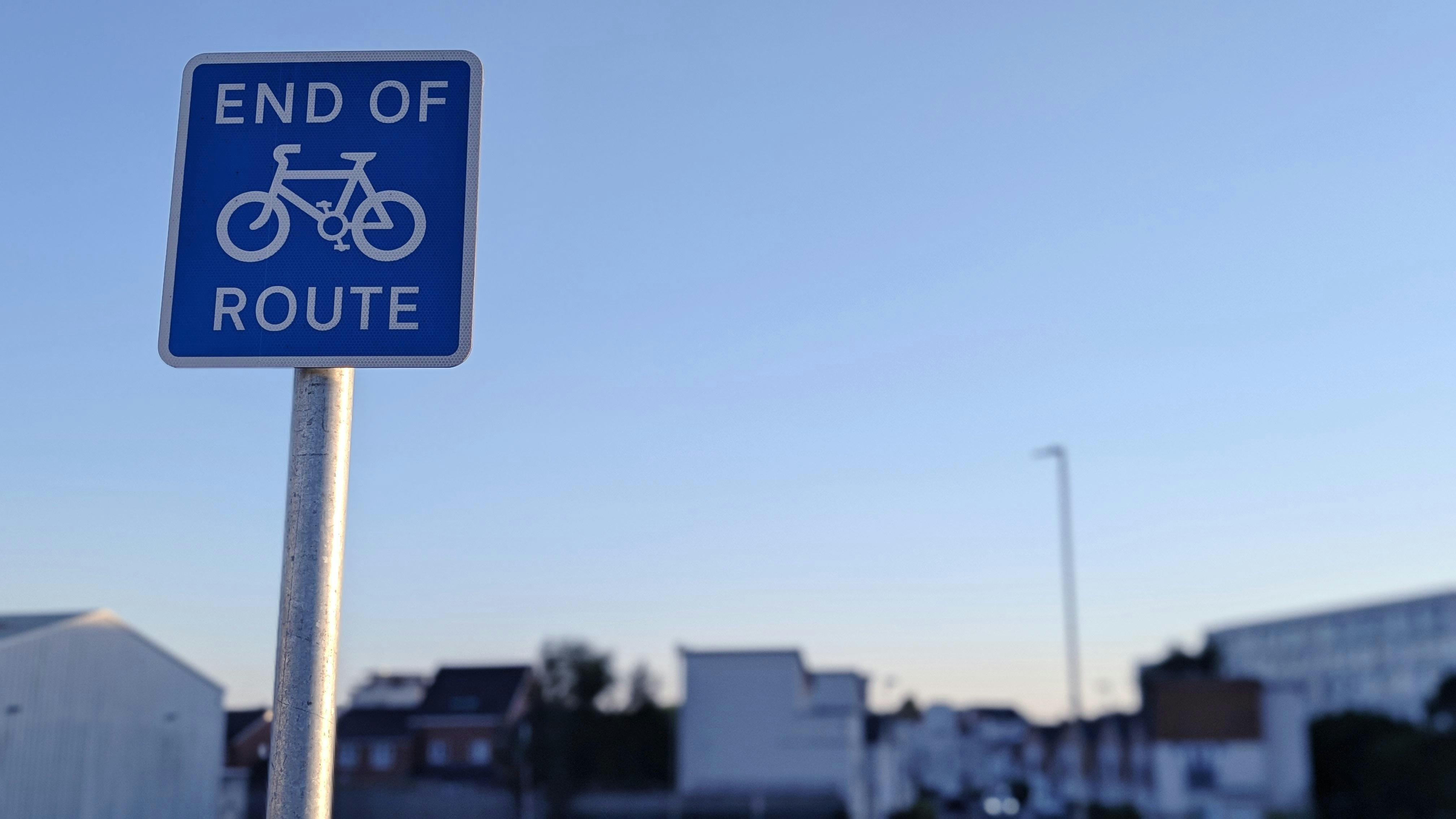 Blue sign indicating the end of a bicycle route.