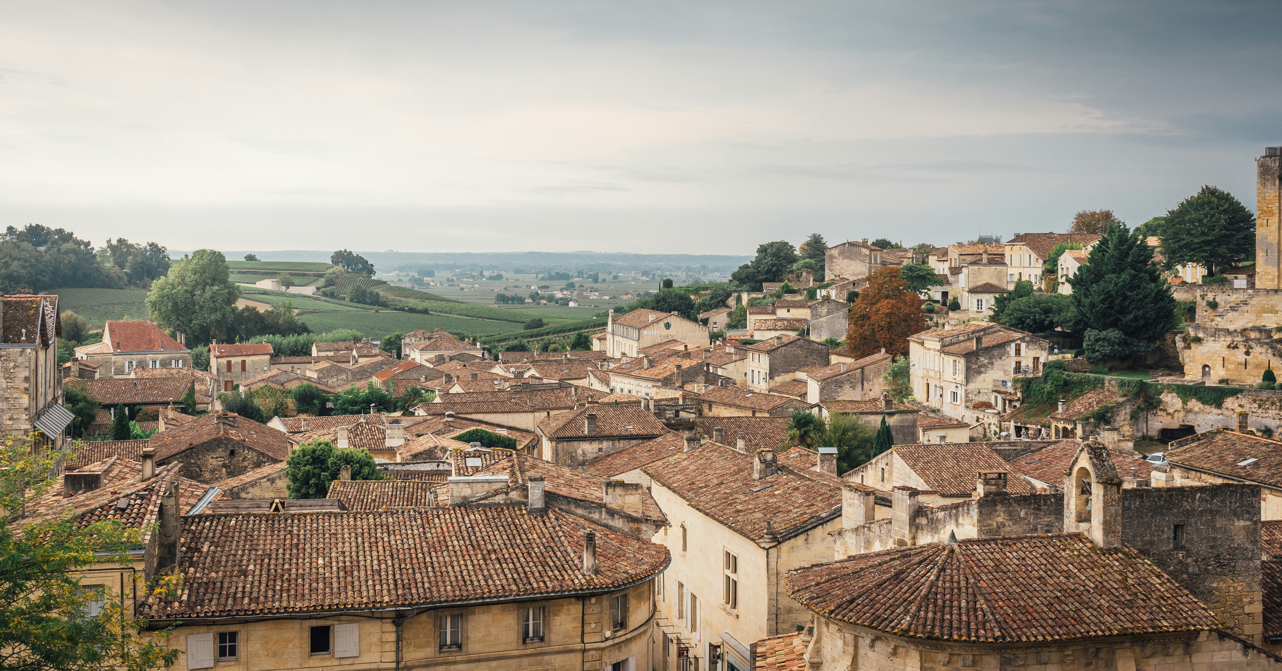 Rooftops of a french village with rolling hills