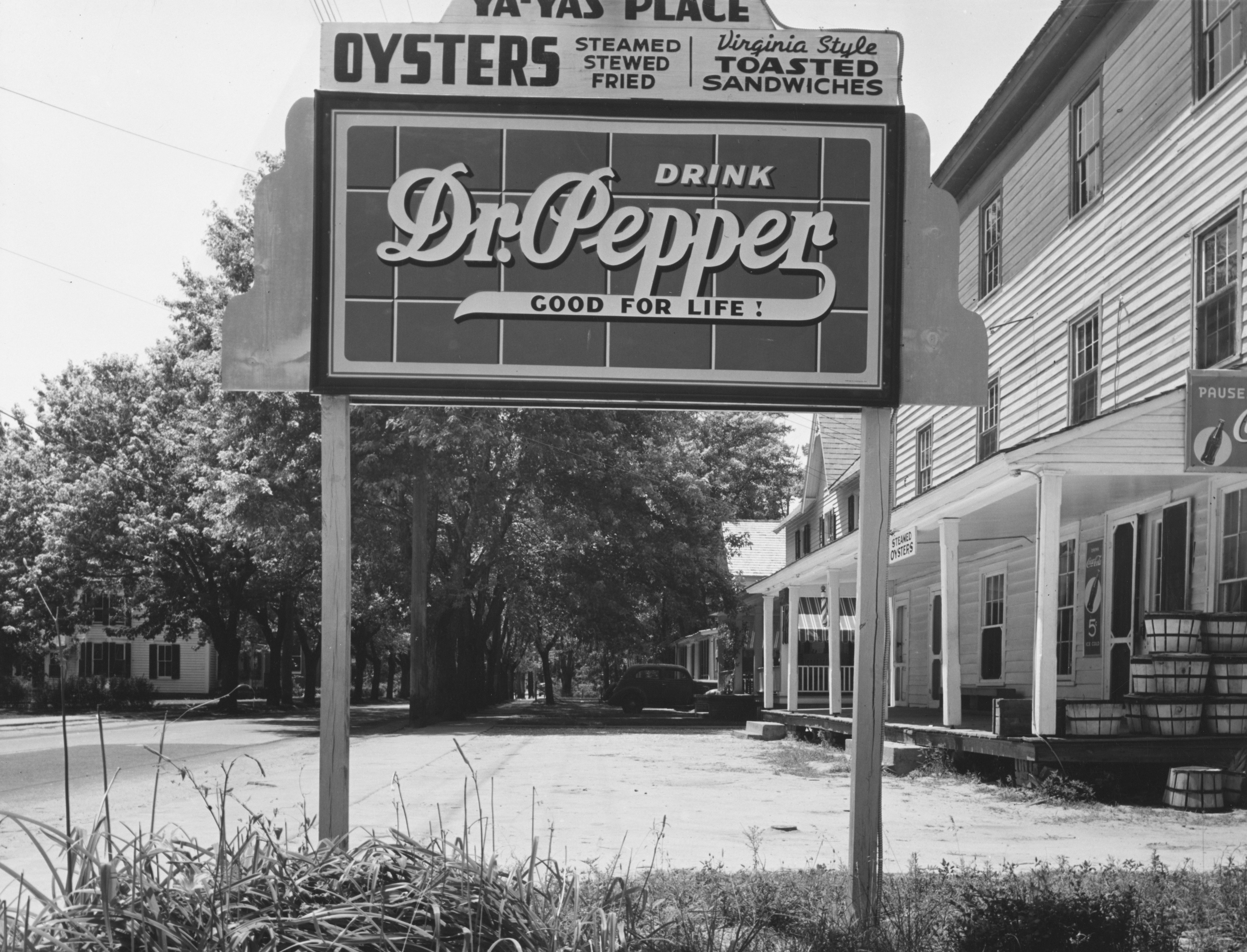 Dr pepper sign outside a building with oysters advertised