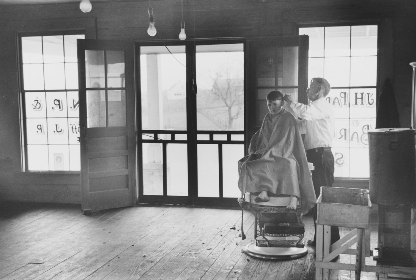 A barber at work in the early days — the craft before the brand