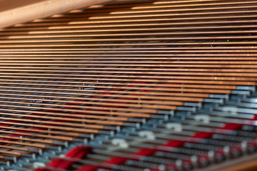 Close-up of piano strings and hammers