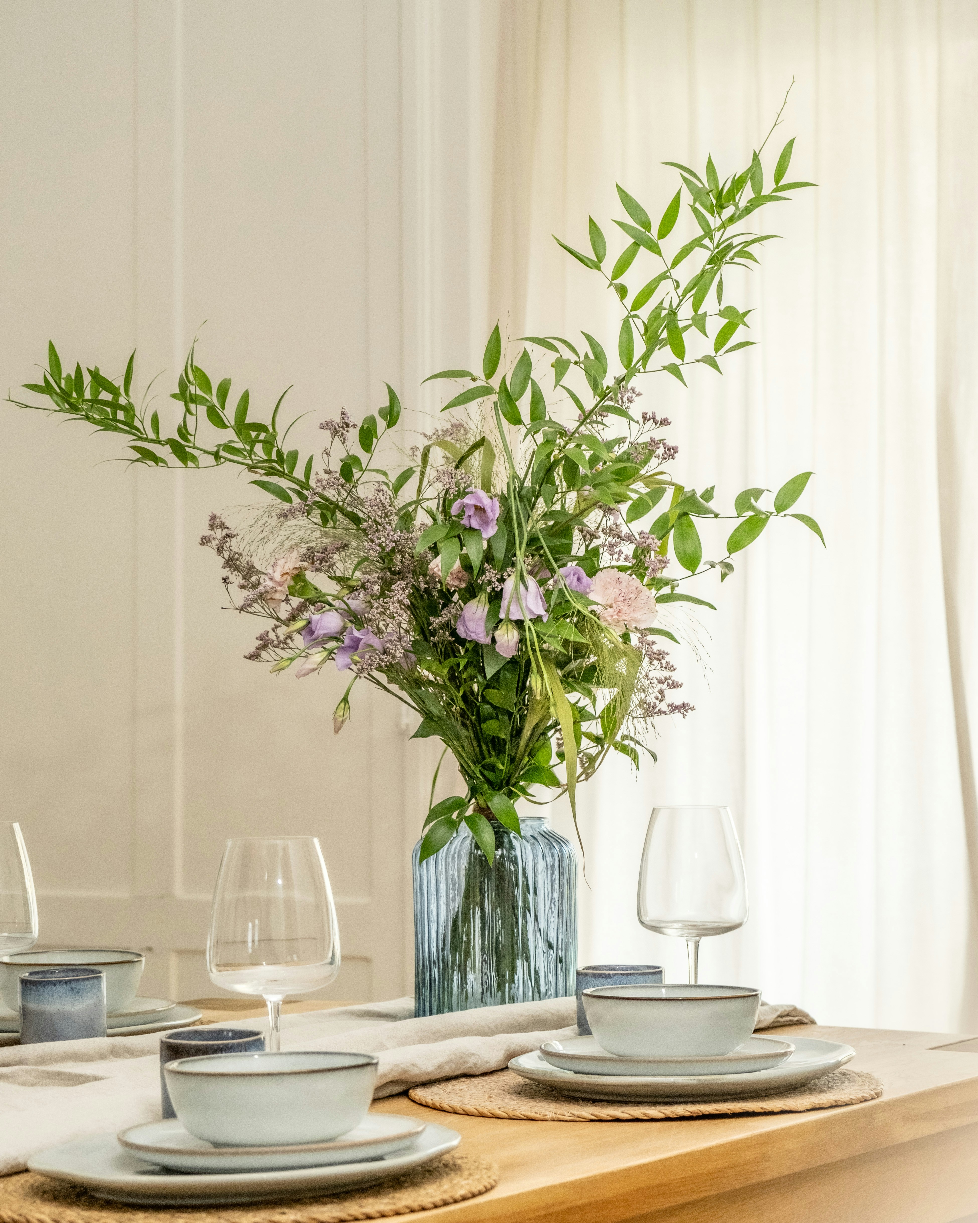 A table setting with a vase of flowers.