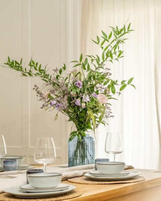 A table setting with a vase of flowers.