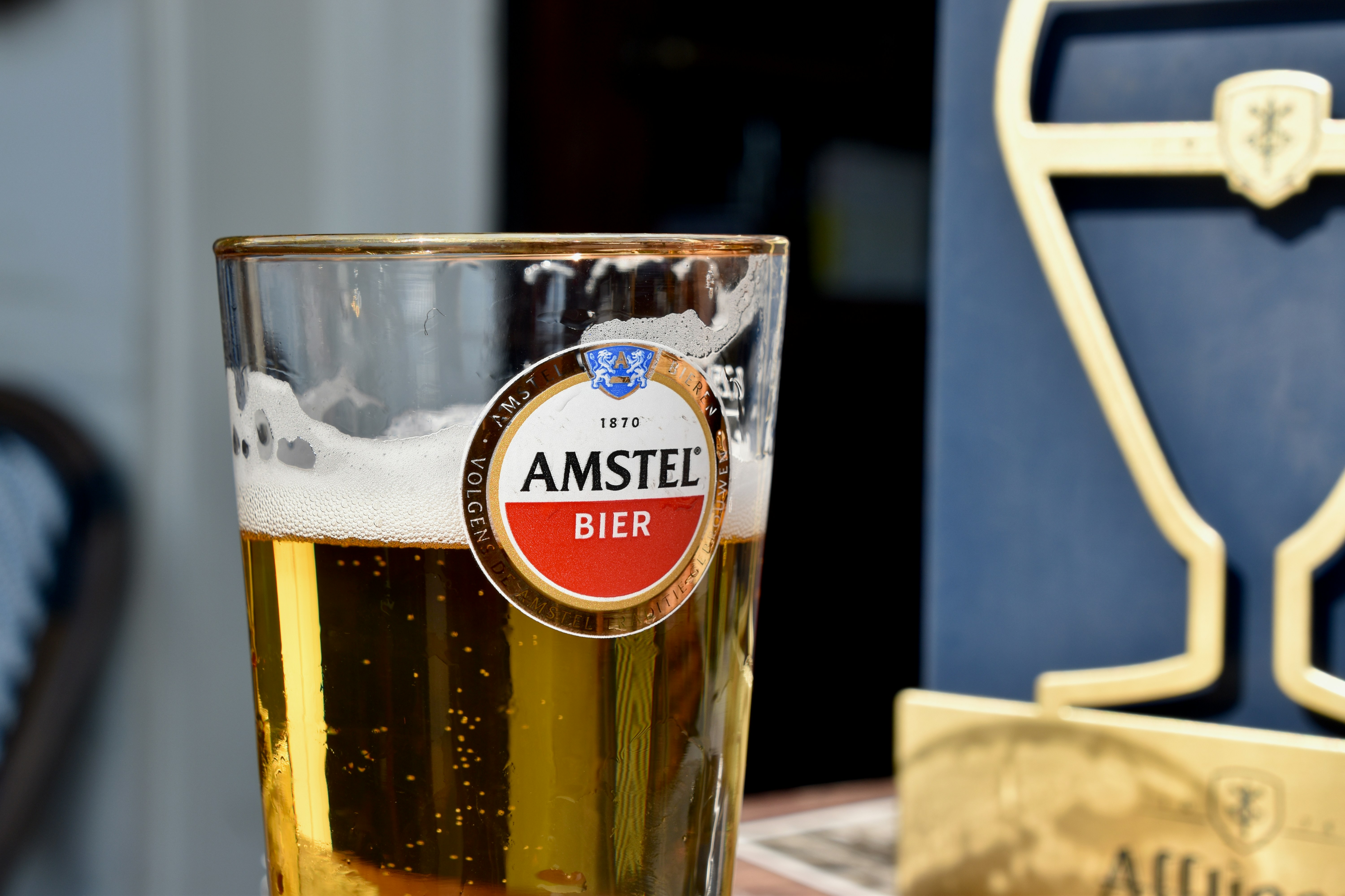 Glass of amstel bier with foam and bubbles