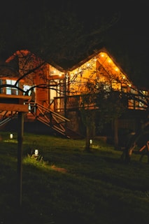Wooden house with string lights at night