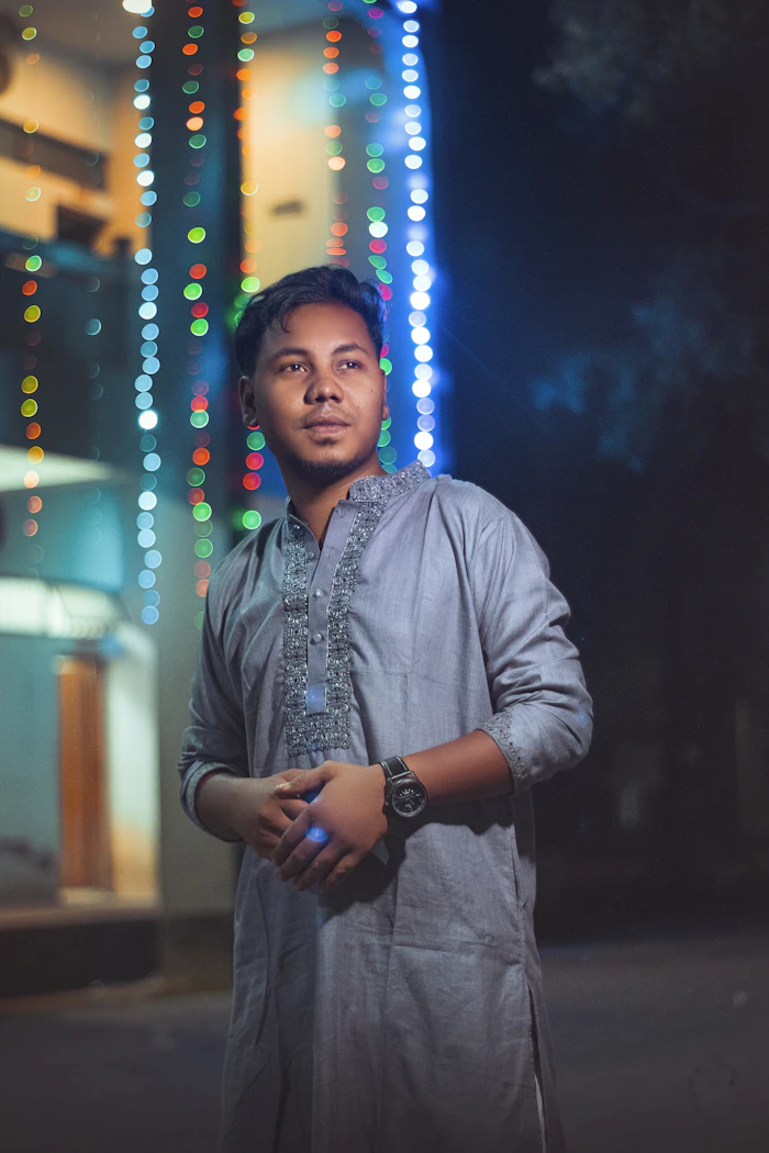 Indian man wearing a premium traditional kurta set with festive bokeh lights