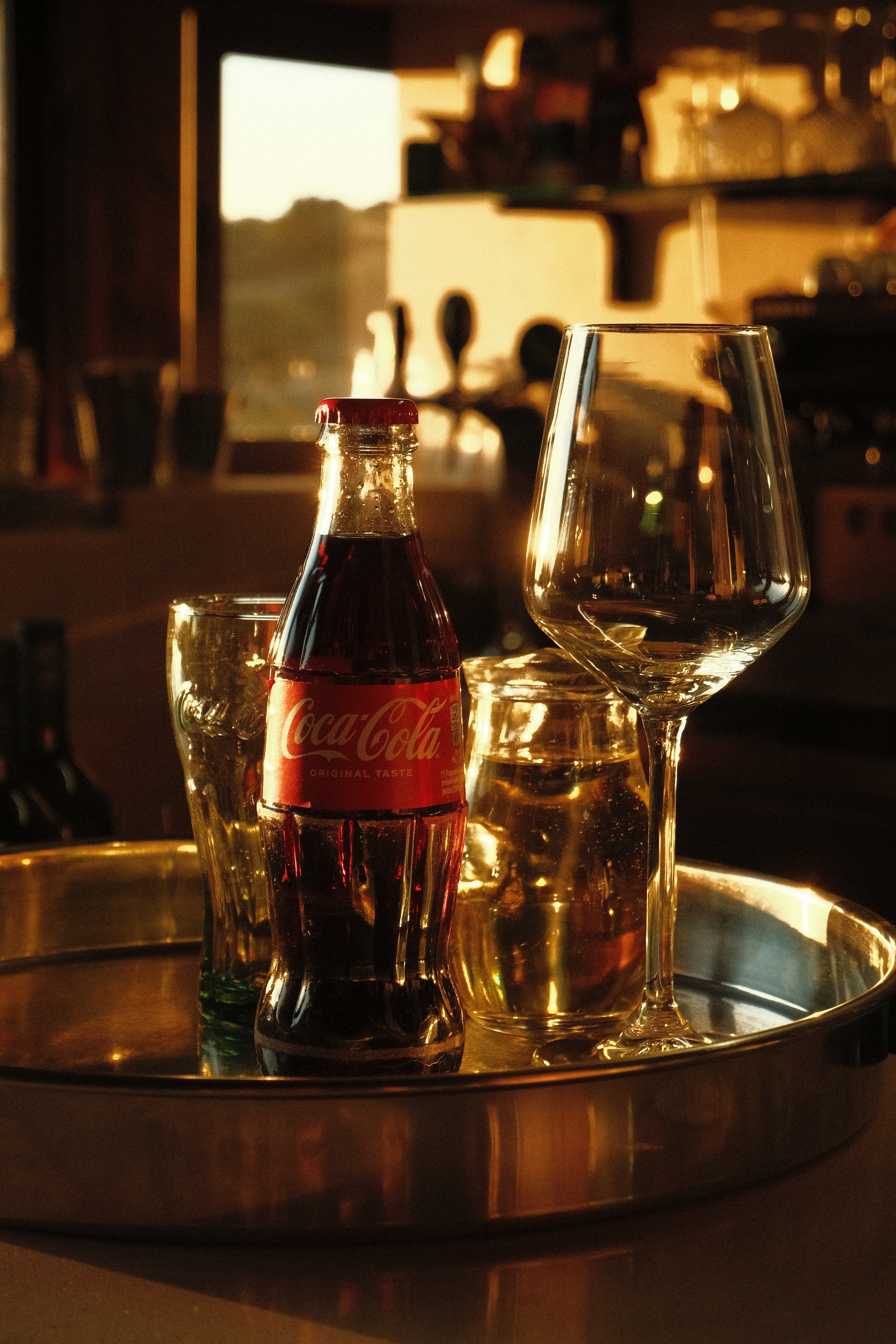 Coca-cola bottle with glasses on a tray