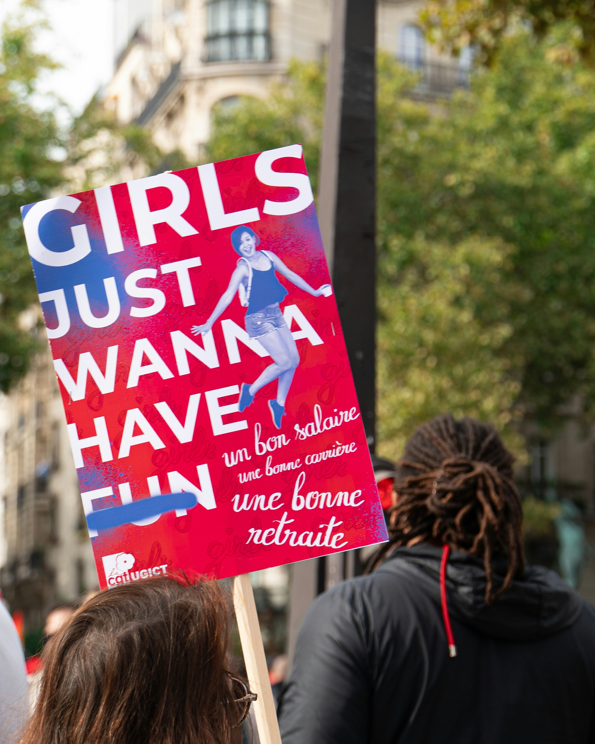 Protest sign with "girls just wanna have fun" slogan.