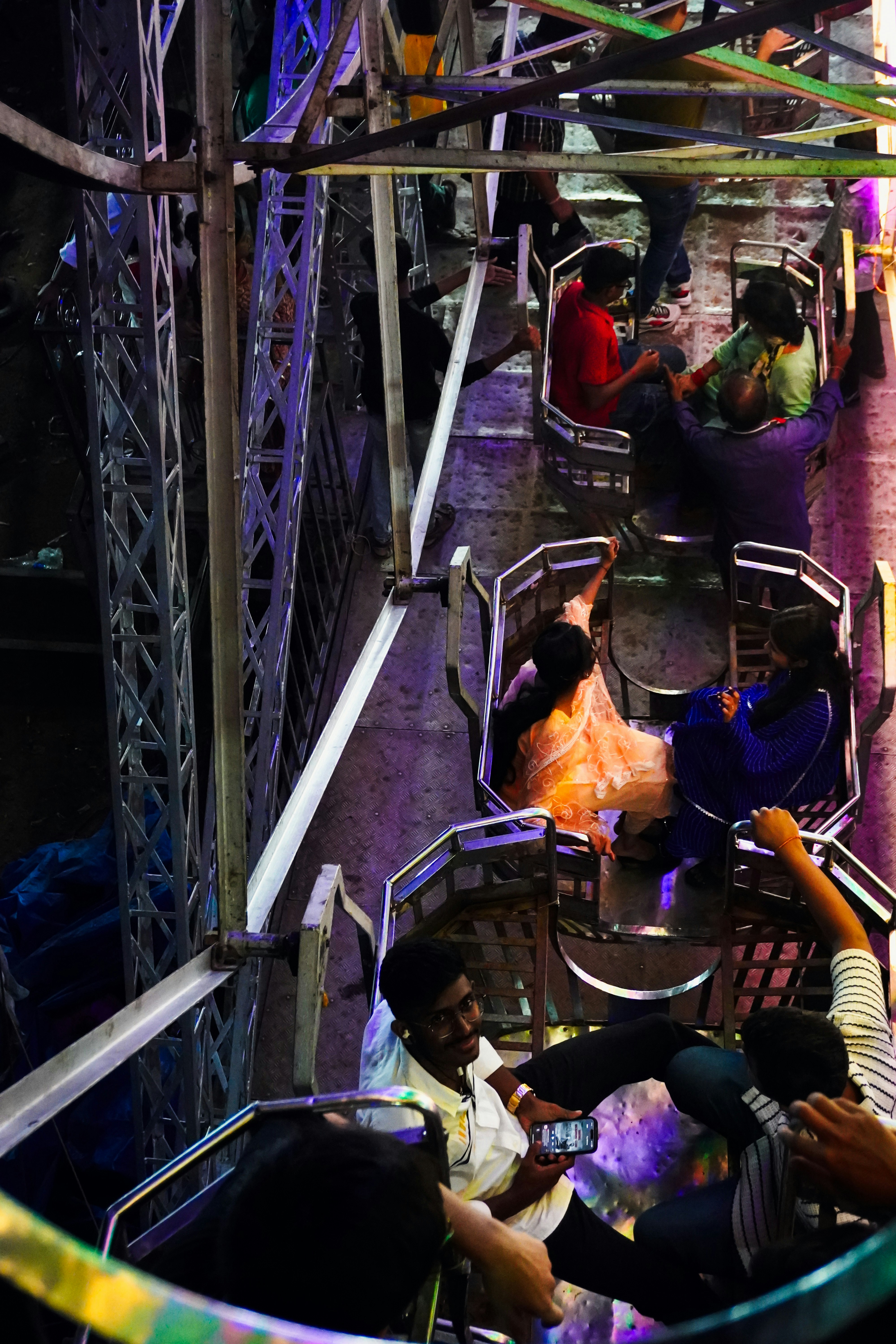 People riding a ferris wheel at night.