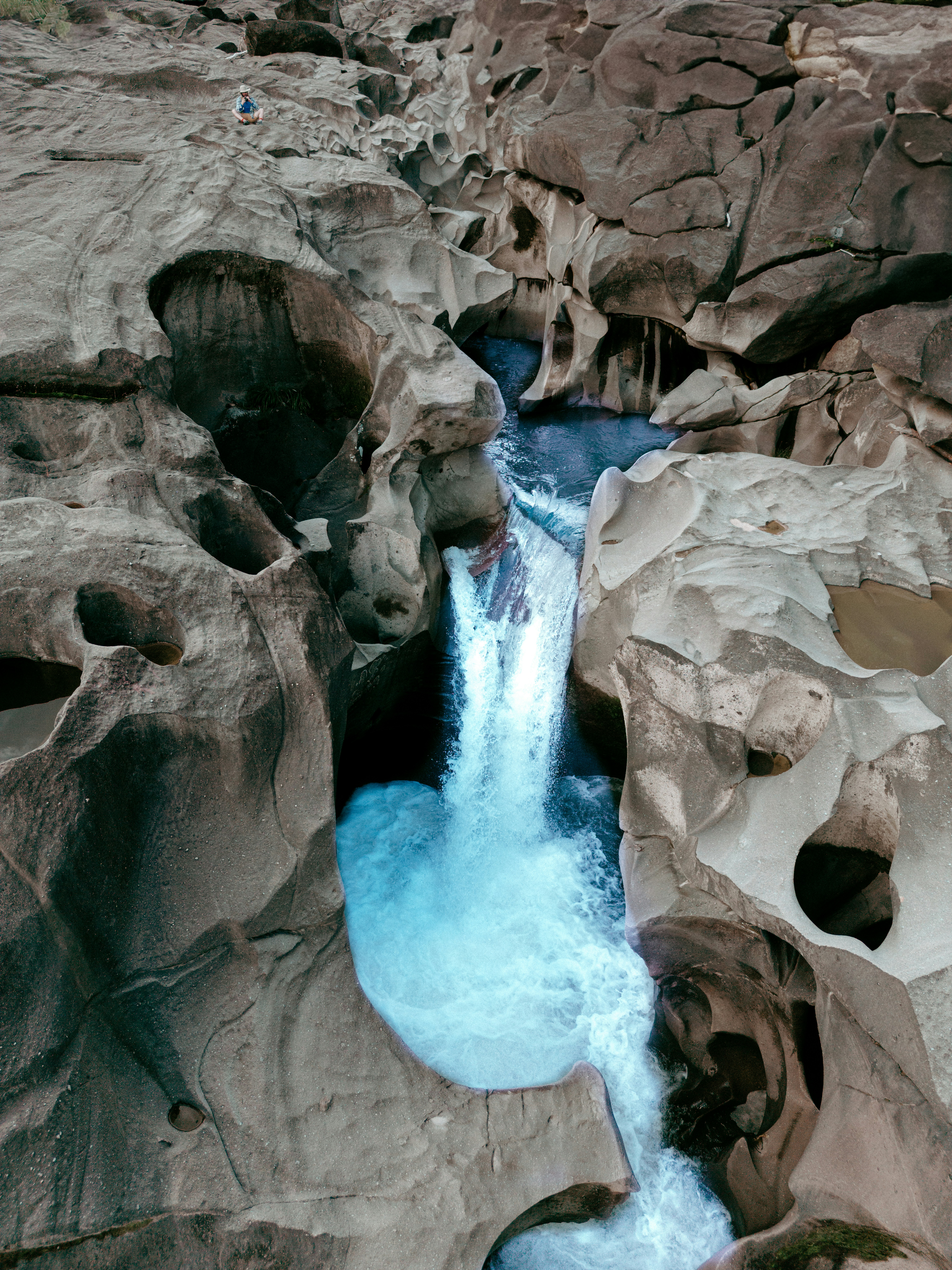 Waterfall flowing through unique rock formations