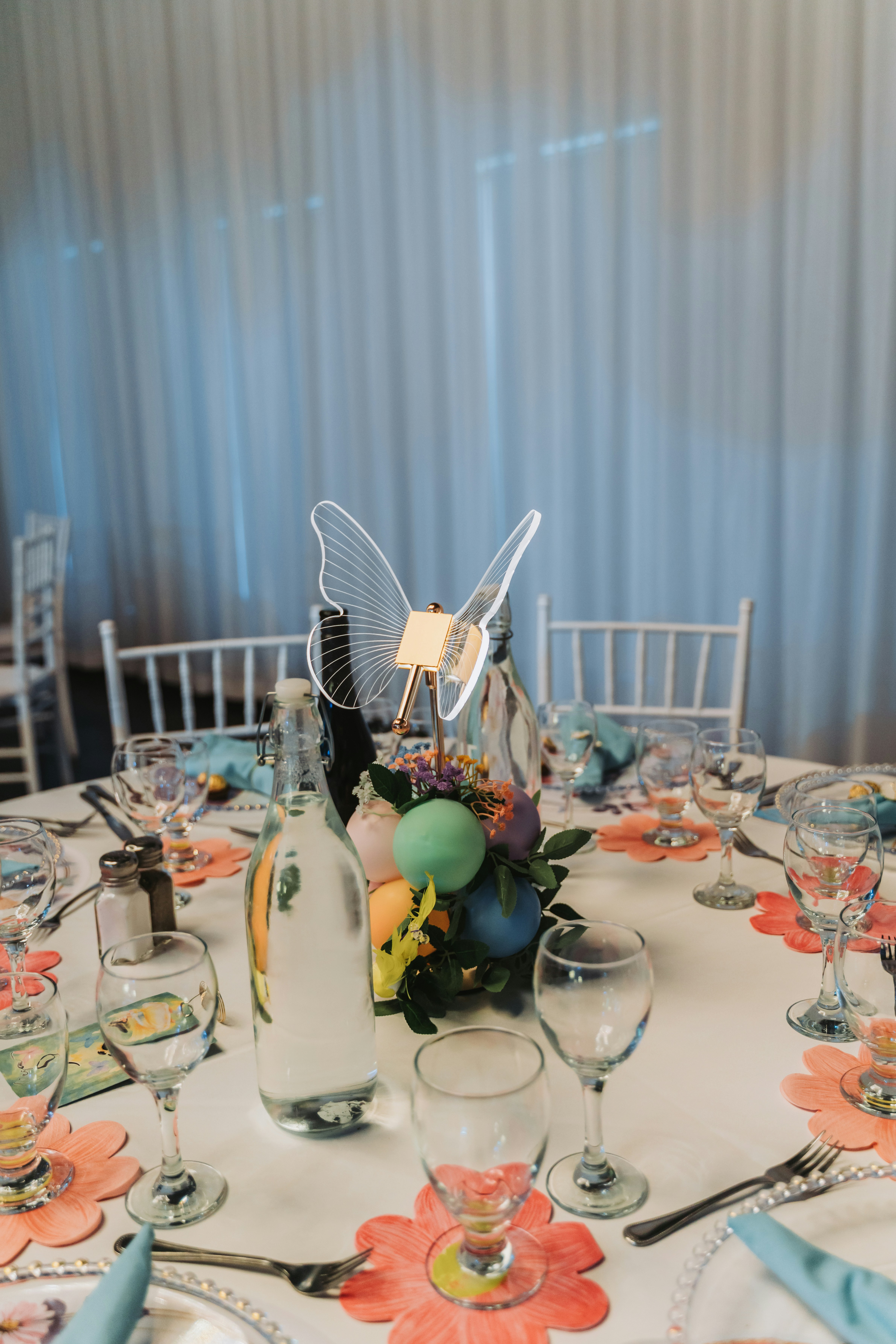 Table setting with butterfly centerpiece and colorful decorations