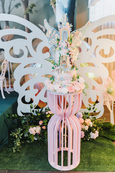 A whimsical fairy-themed cake with floral decorations