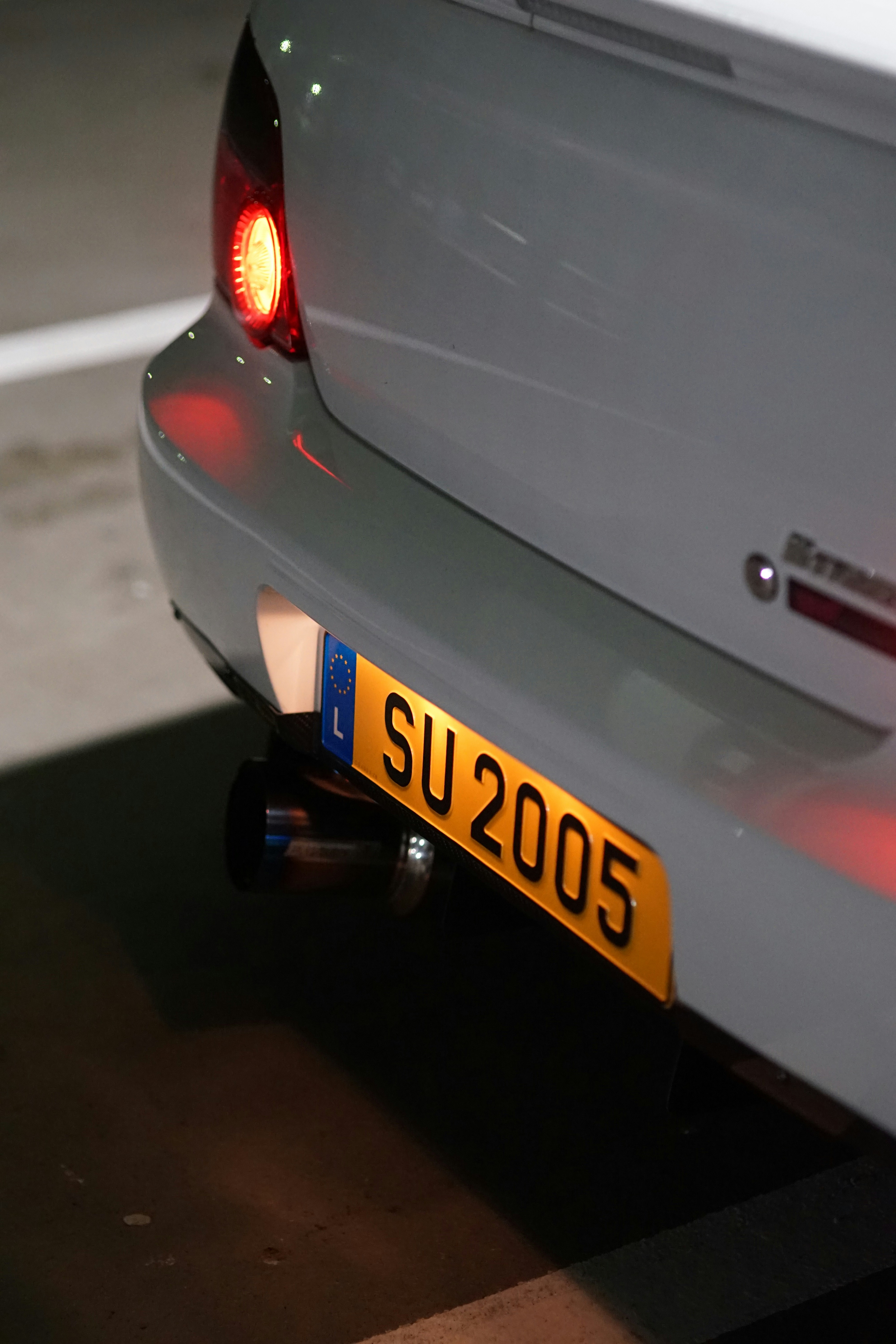 Close up of a white car's rear with license plate.