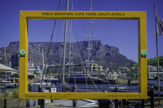 Table mountain framed by a yellow structure in cape town.