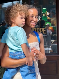 Woman holding a young child outdoors