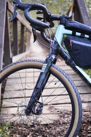 Handlebar bag mounted on a drop-bar gravel bike with a mountain backdrop