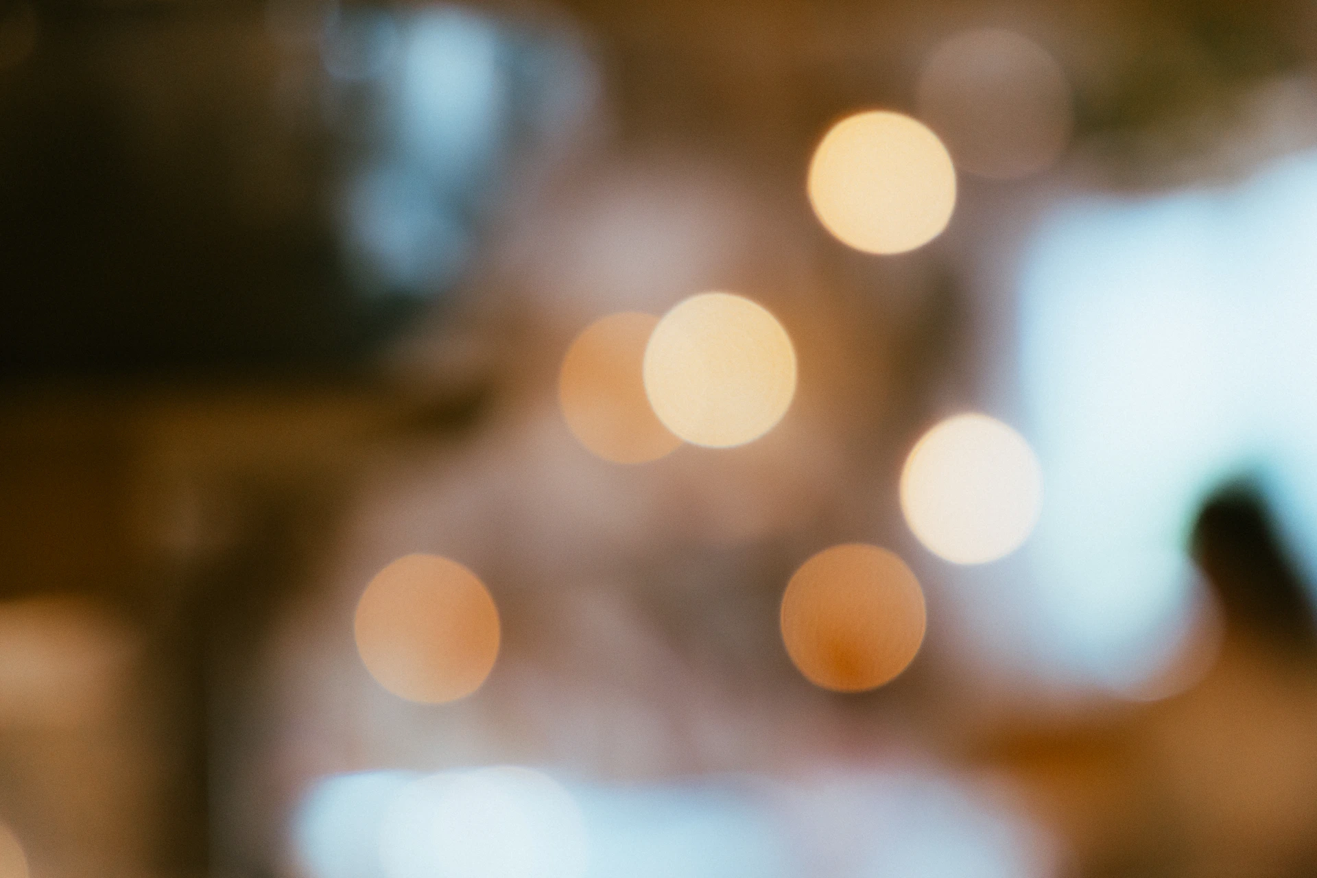 Blurred warm lights in a dimly lit room.