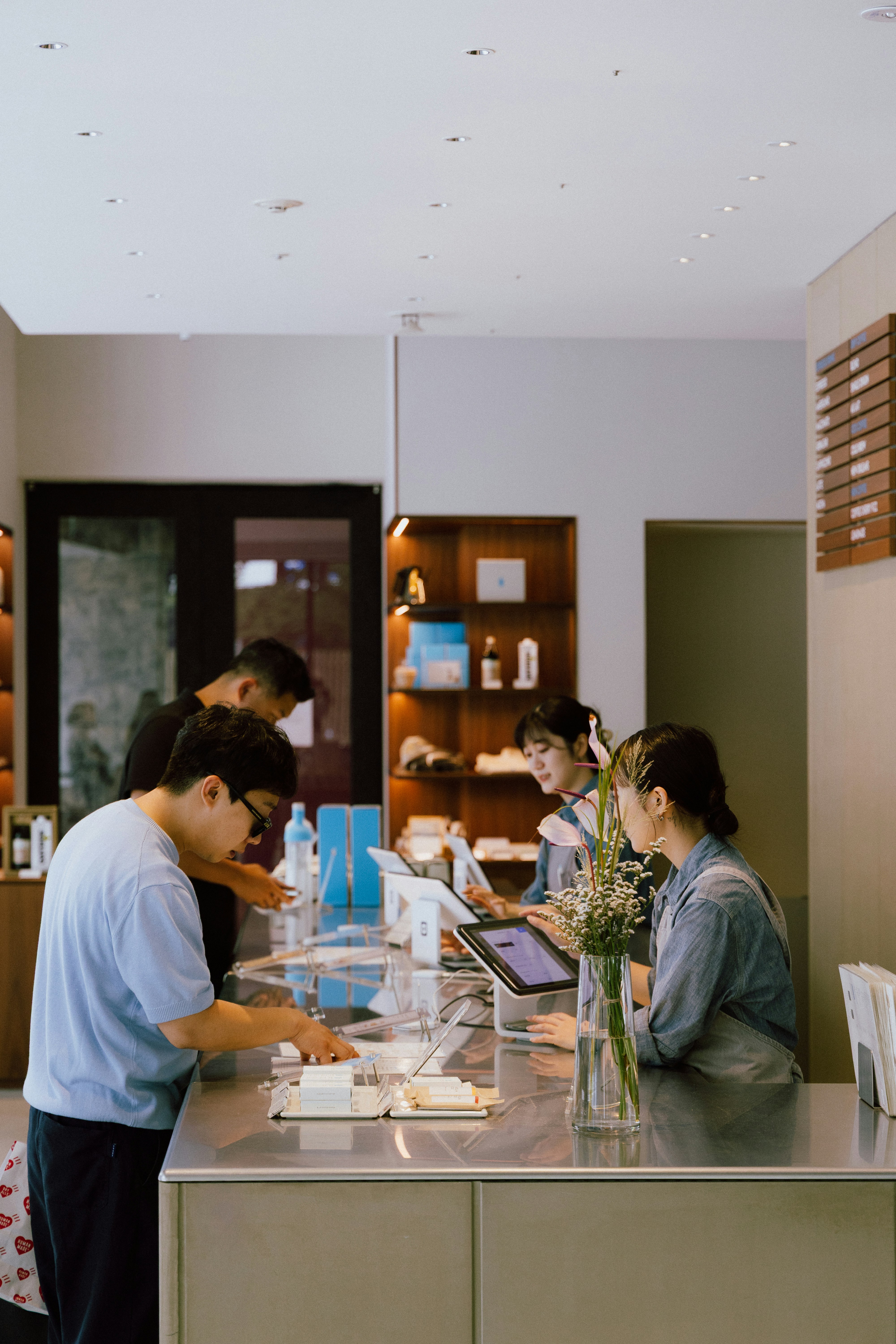 People interacting at a modern retail counter.