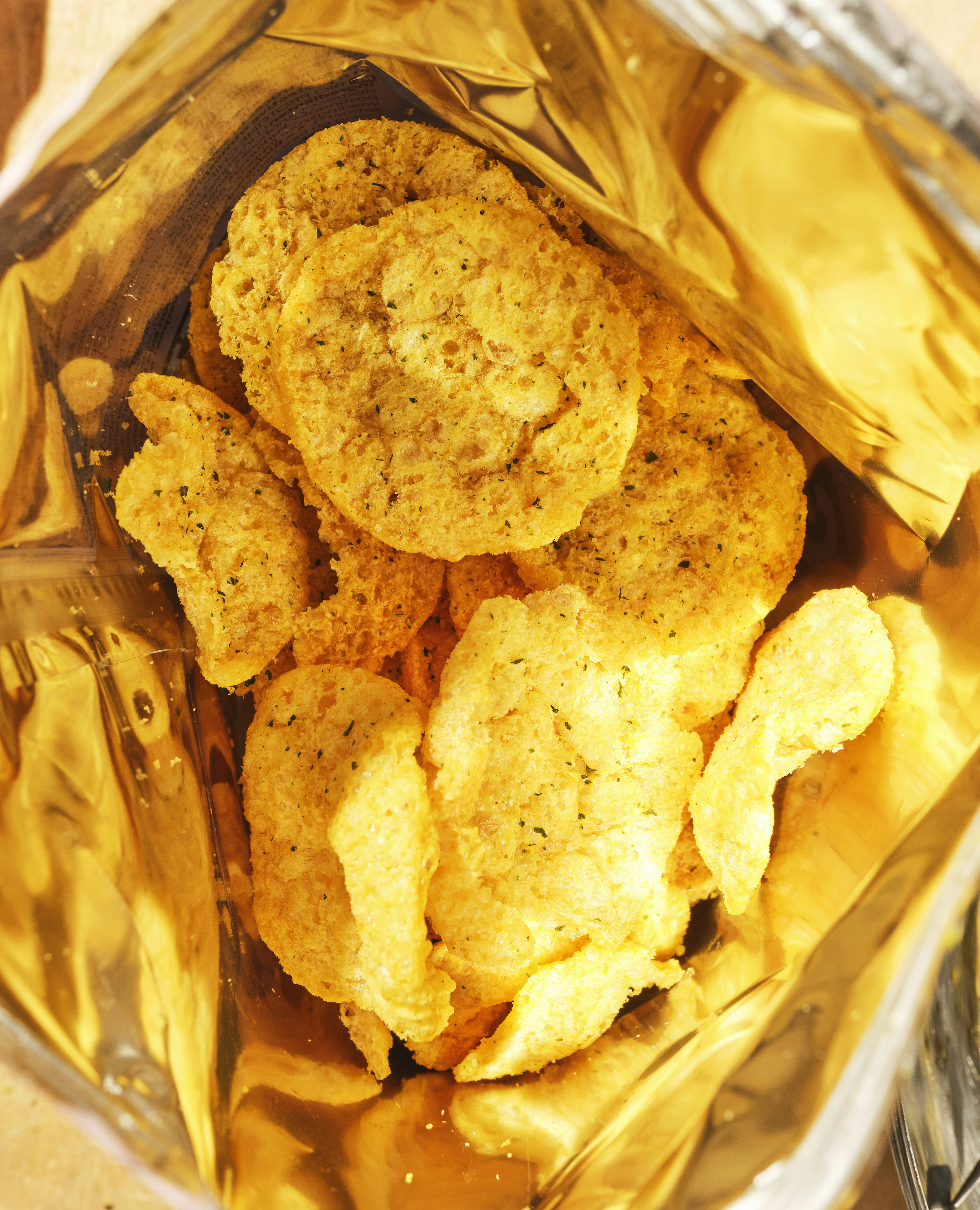 Crispy potato chips inside a golden bag