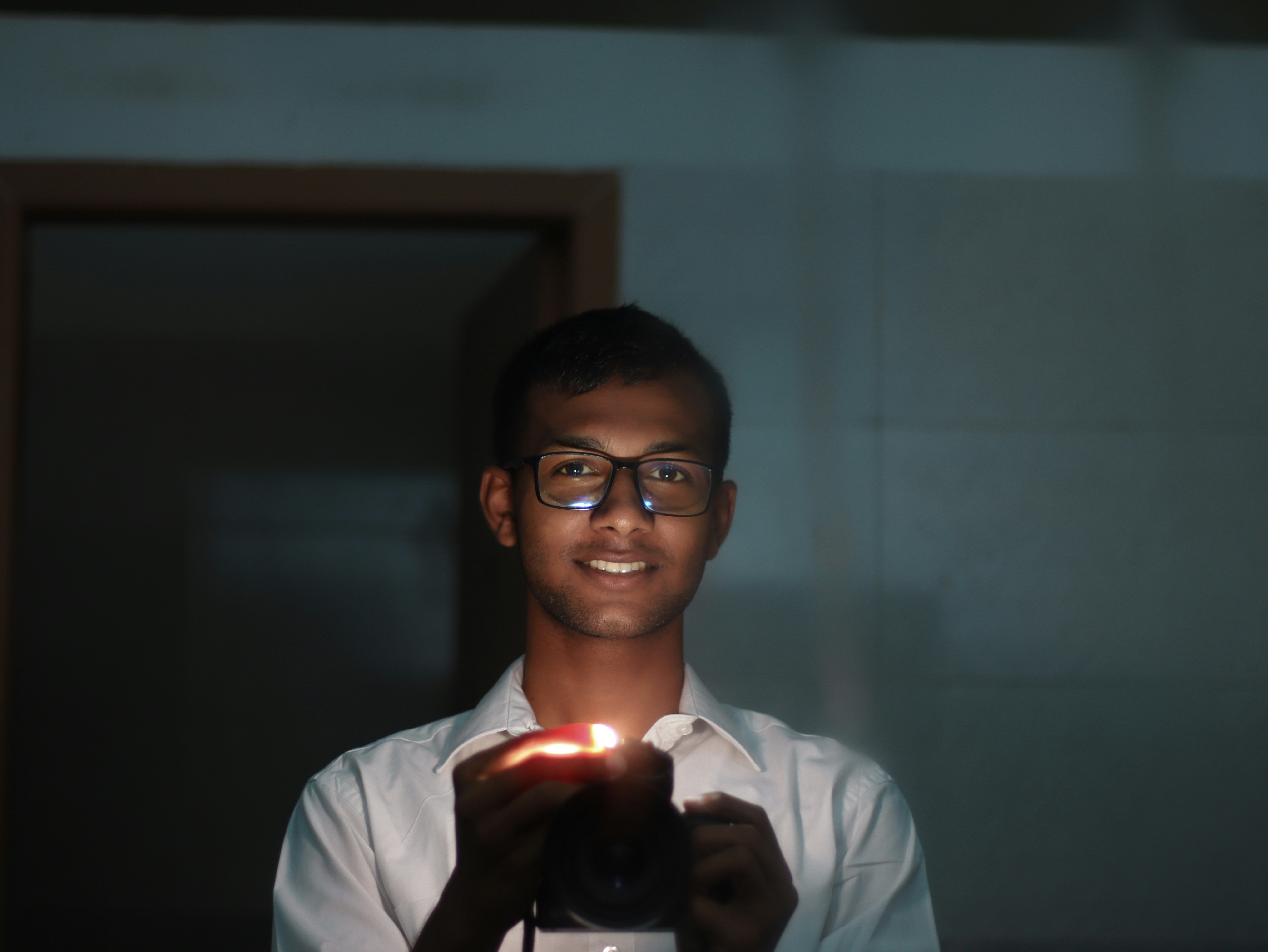 person using a candle to detect a window draft - prevent window air leaks