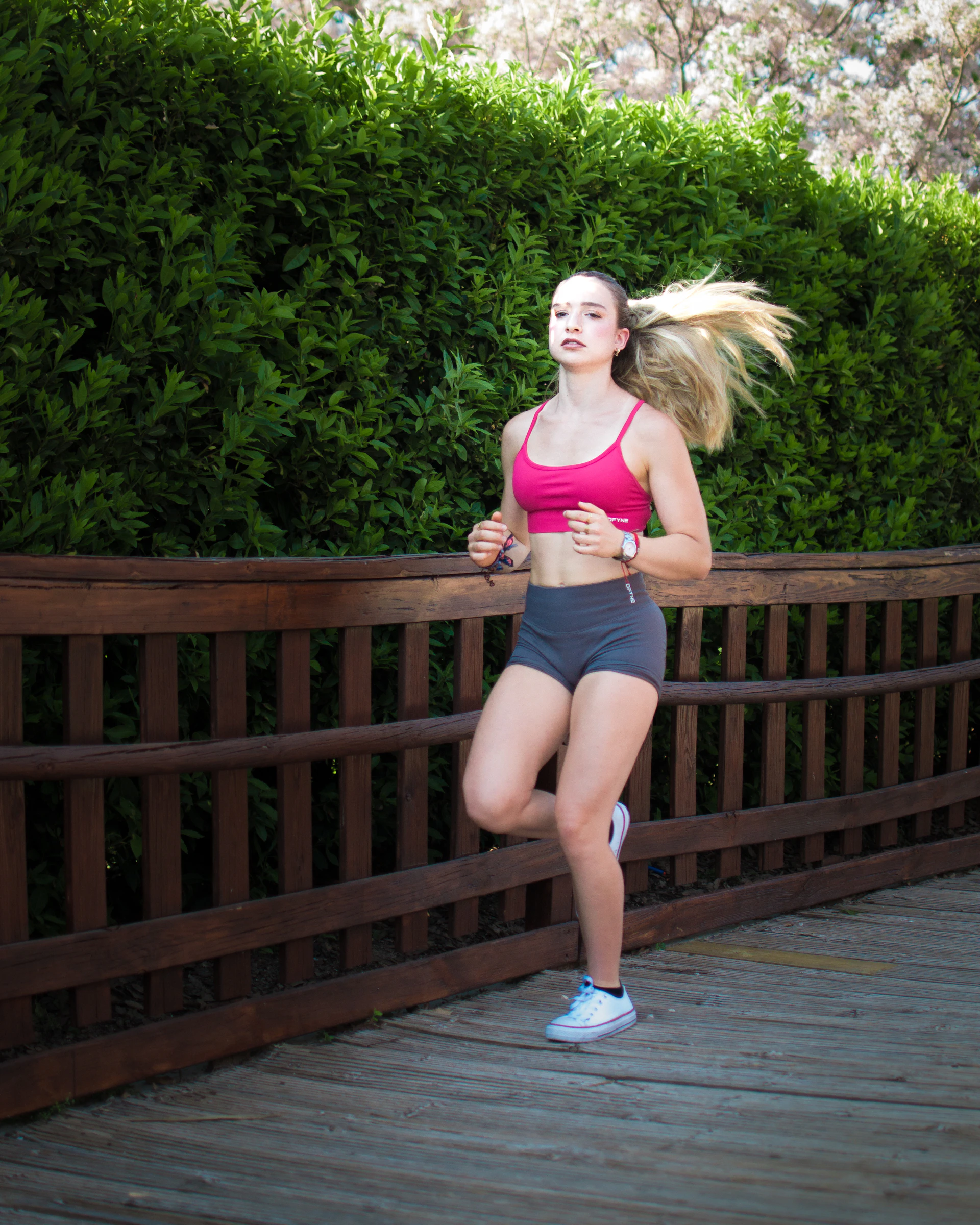 Young woman jogging on a wooden path outdoors path
