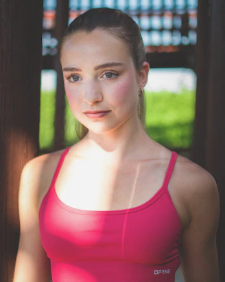Young woman with blonde ponytail in pink top