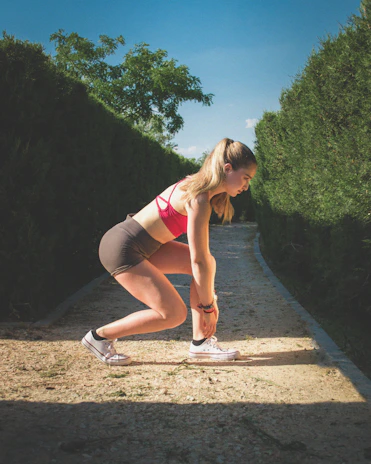 Mulher com roupa esportiva na linha de largada pronta para corrida, fitness e emagrecimento.