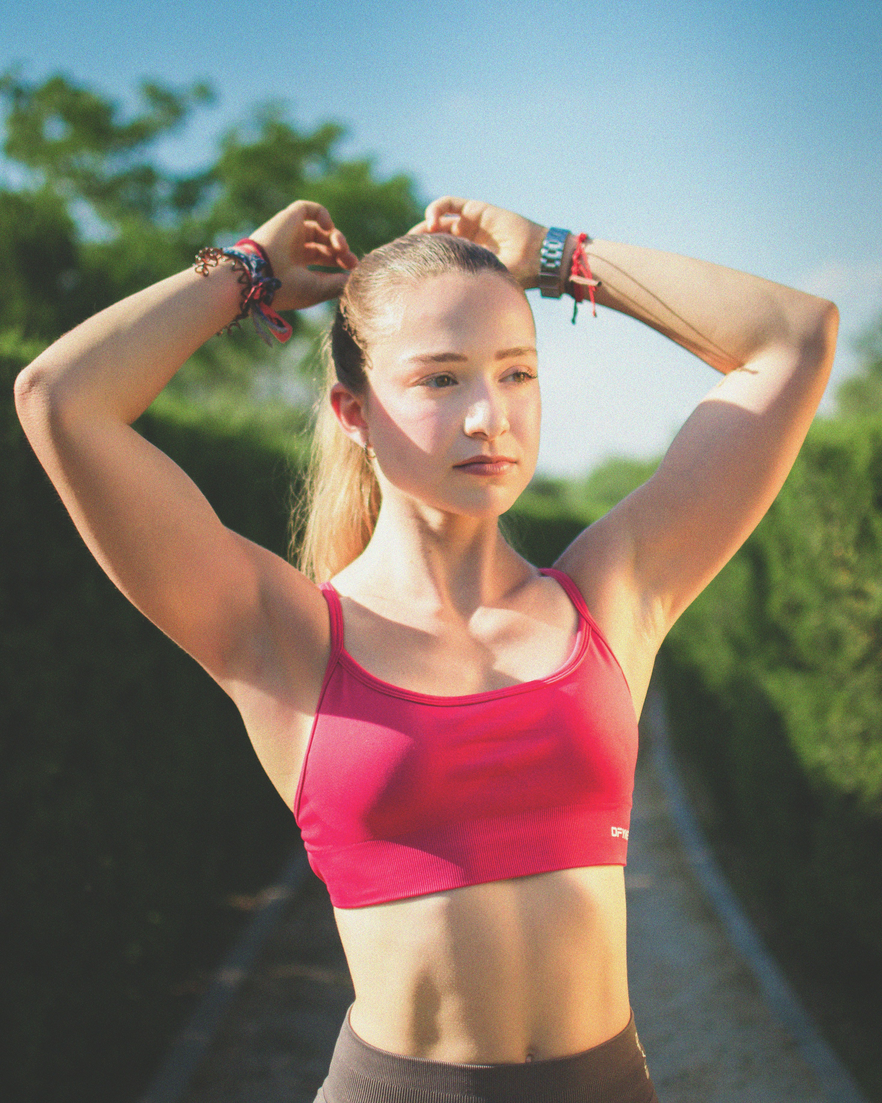 Young woman tying her hair before workout