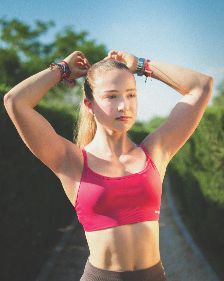 Portrait of coach Maren Cole tying her hair back before training