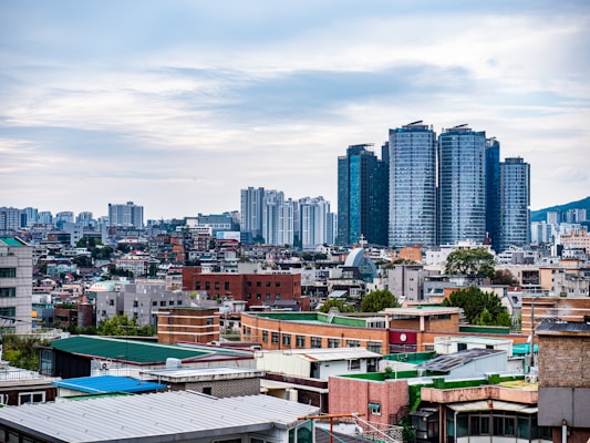 Modern city skyline with tall buildings under cloudy sky