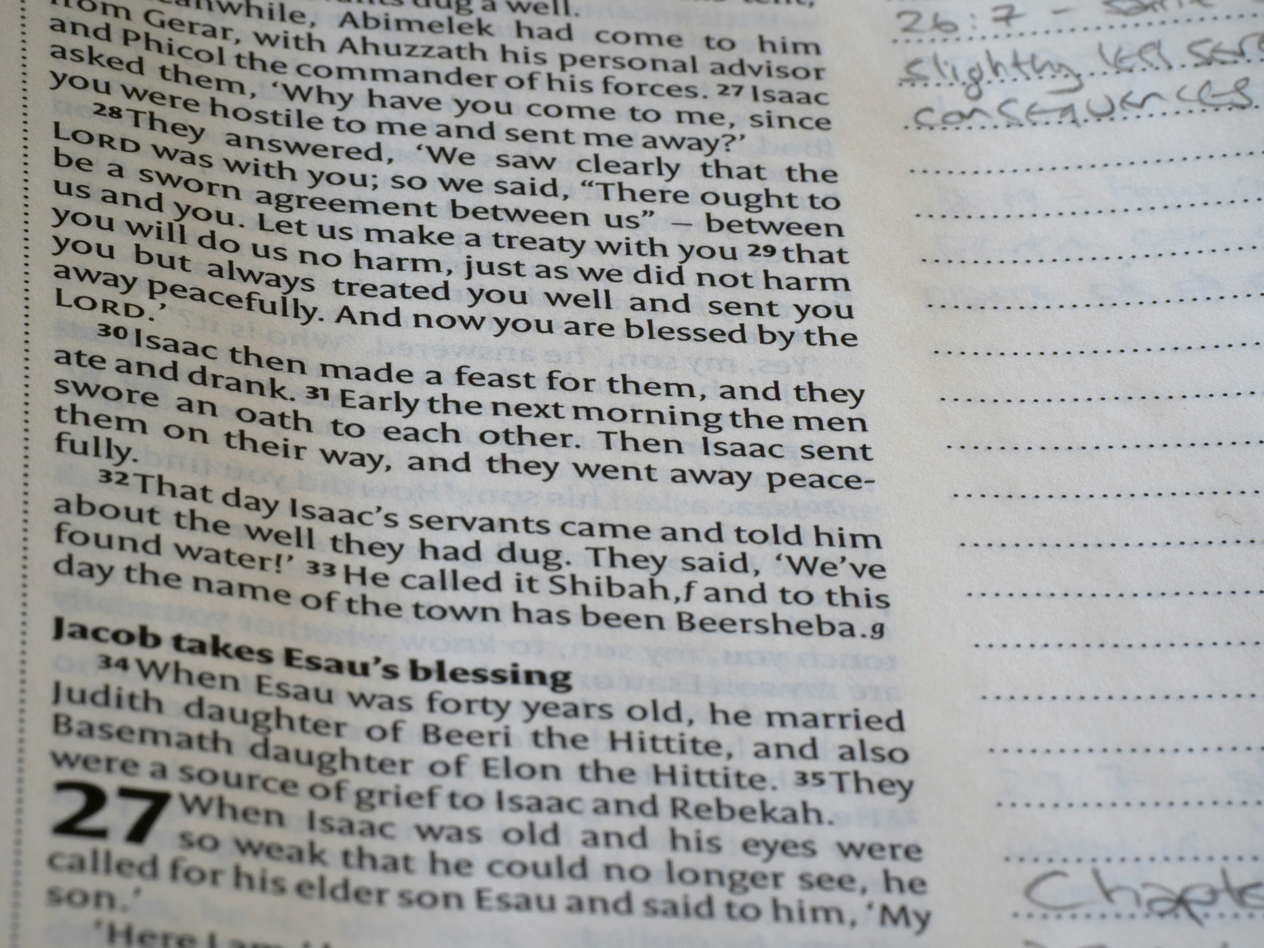 Close-up of an open book with text and handwriting.