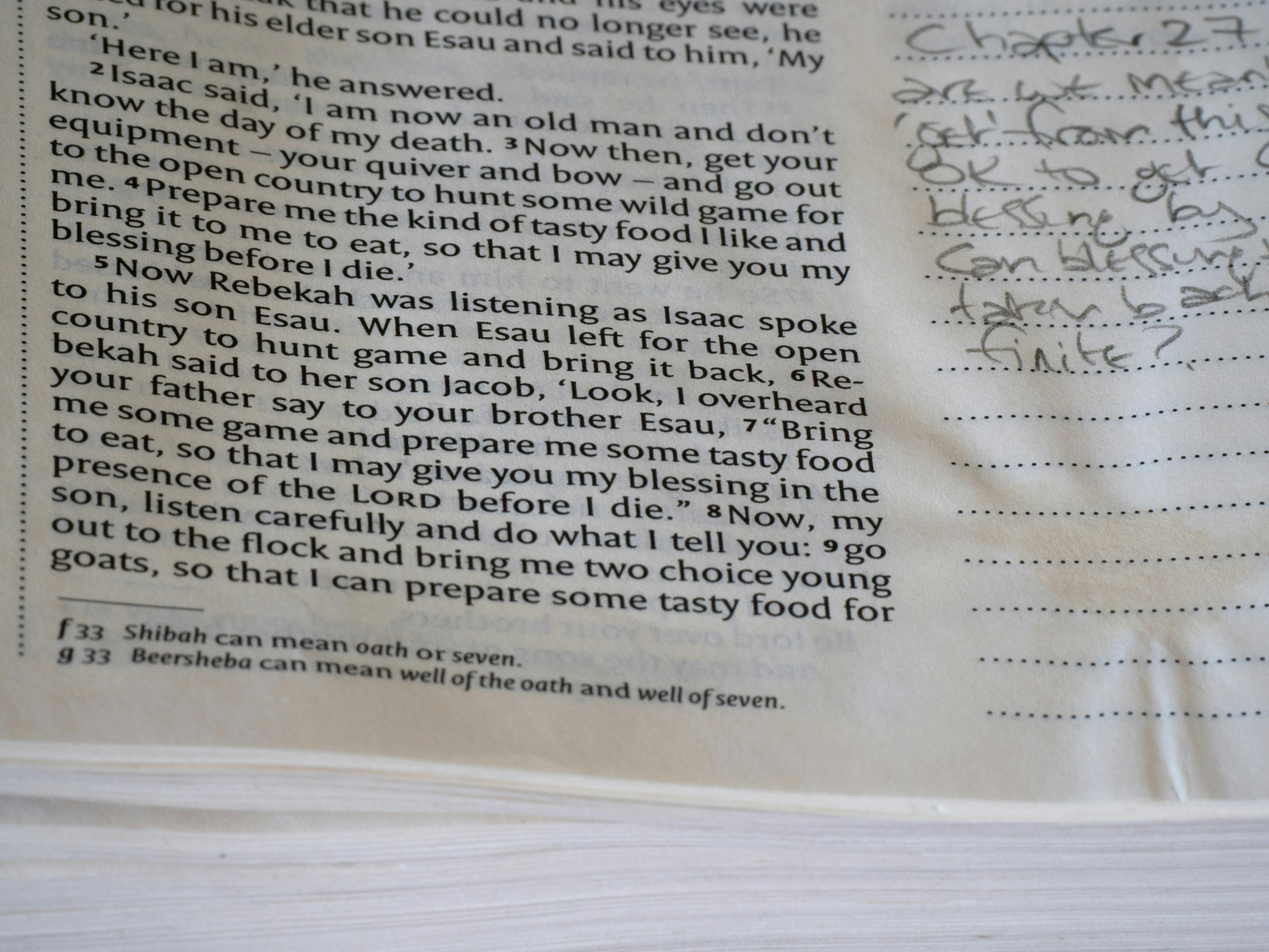 Close-up of an open bible page with handwritten notes.