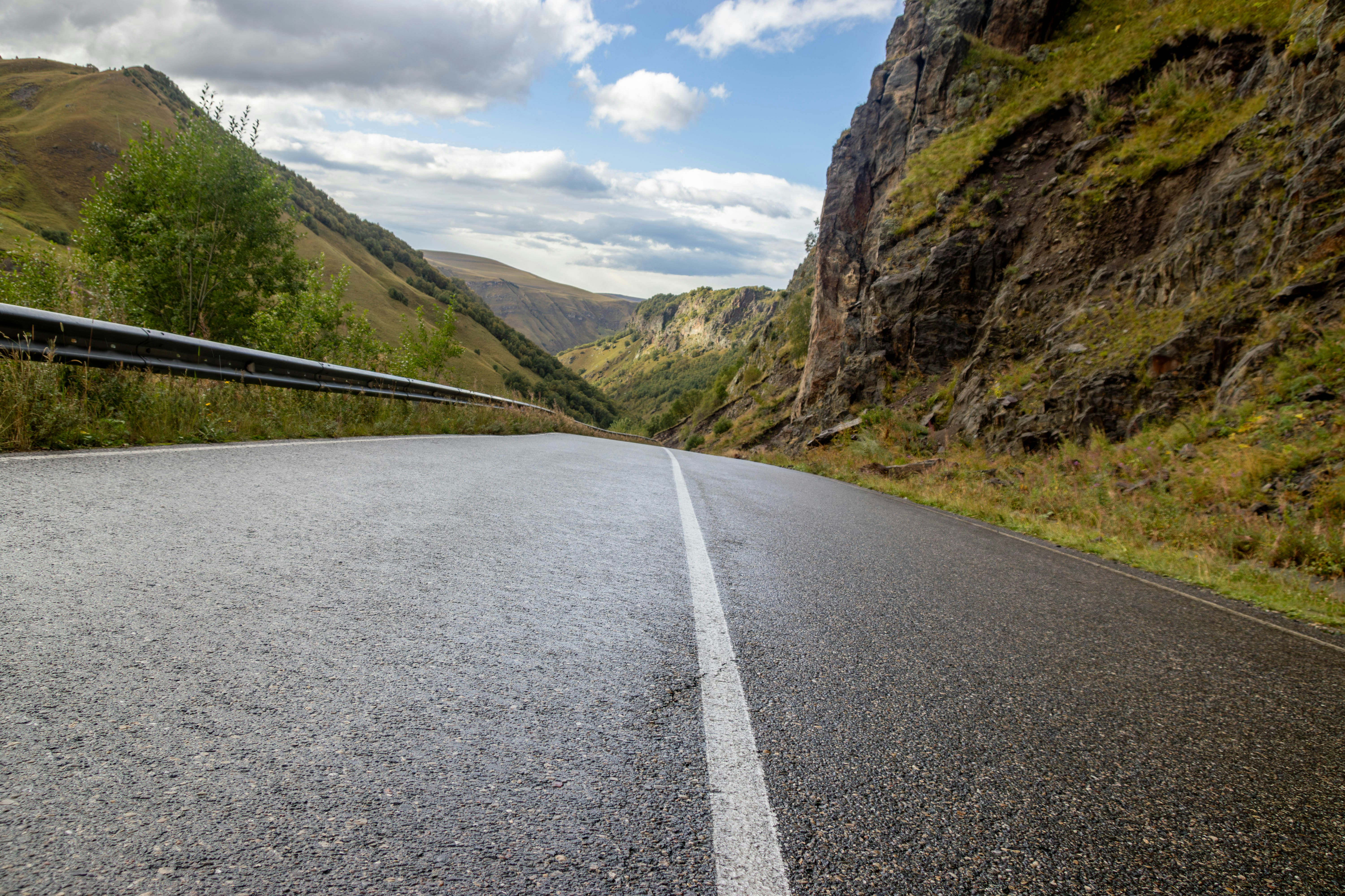 Empty asphalt road through a mountain valley.