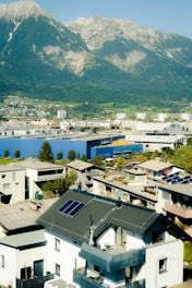 A town nestled at the base of a large mountain.